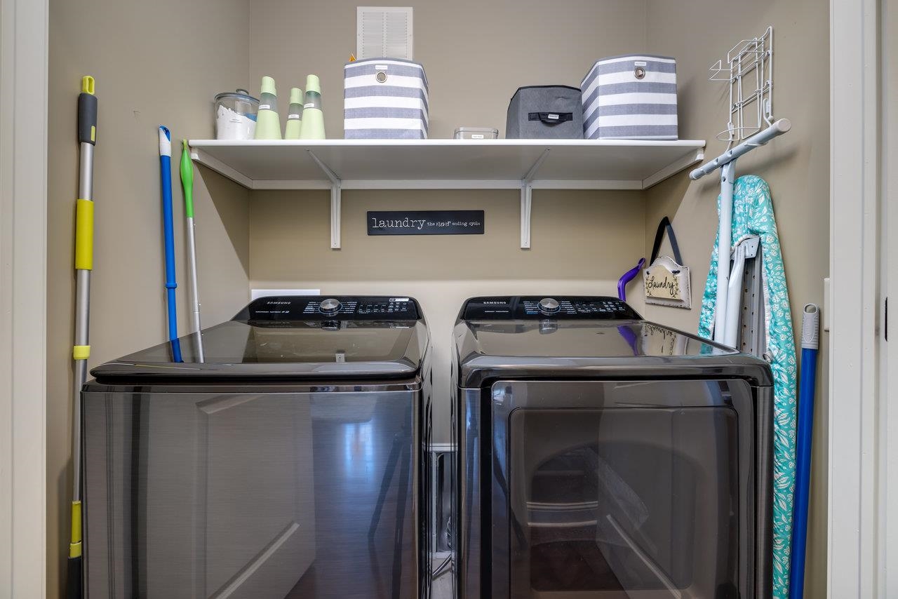 The laundry area is tucked away in the hall away from the main level area but directly adjacent to the primary suite.