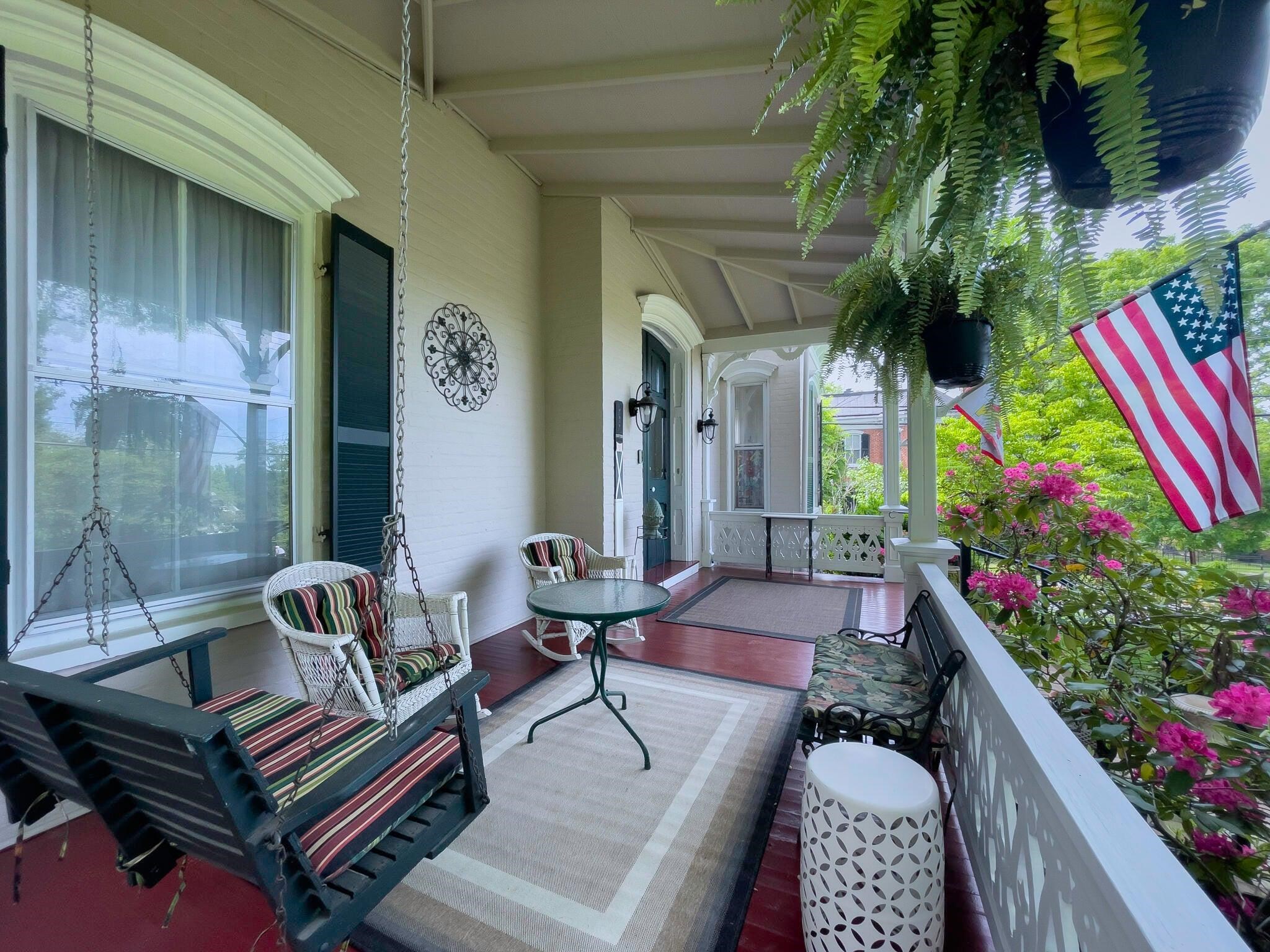 Swing on your porch swing. The curved window trim is the Italianate influence on the architecture.