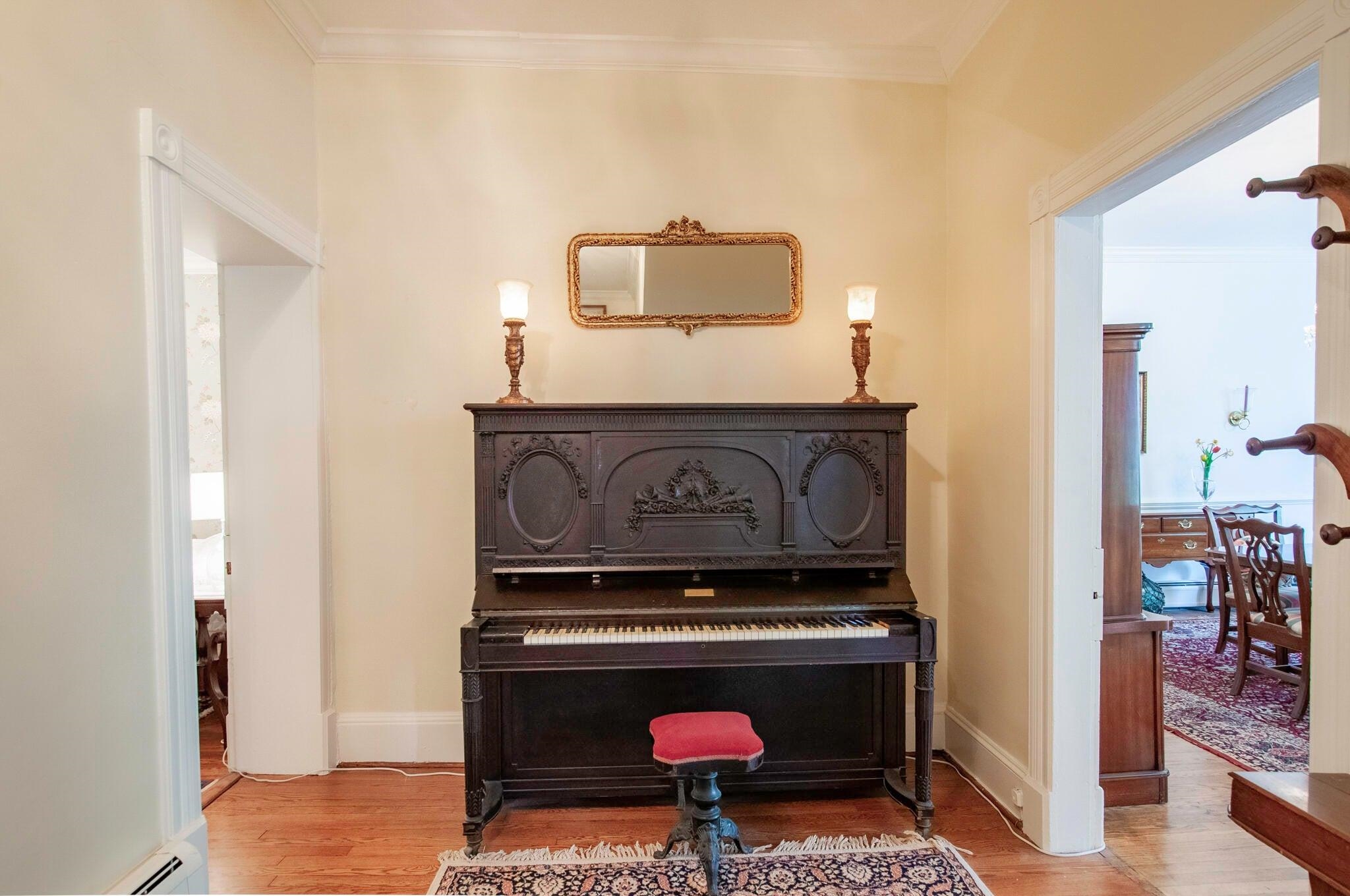 Entry foyer features an antique piano.