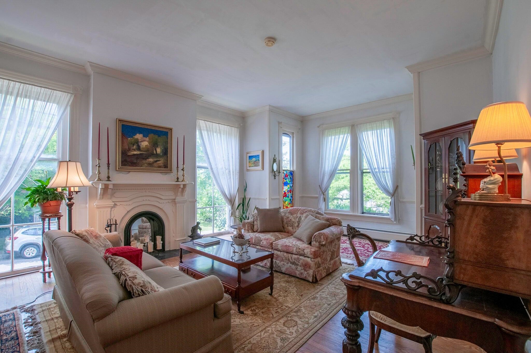 Living room features floor to ceiling windows.