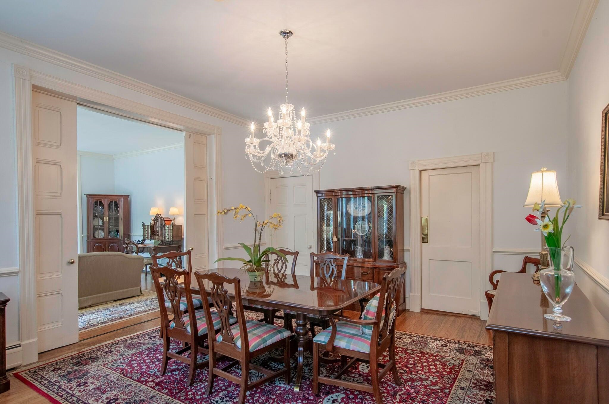 Large, vintage sliding wooden doors separate the living room and dining room.