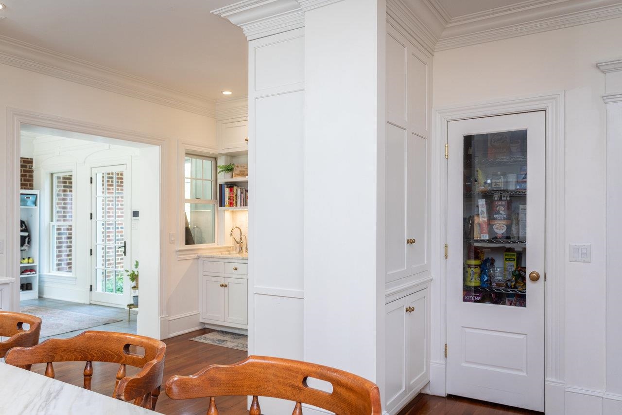 In addition to the pantry closet, there are adjoining cabinets for storage