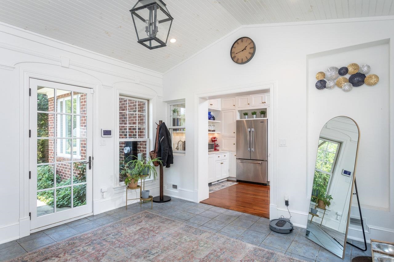 This area between the kitchen and garage is an all season room filled with natural light and is adjacent to the backyard patio