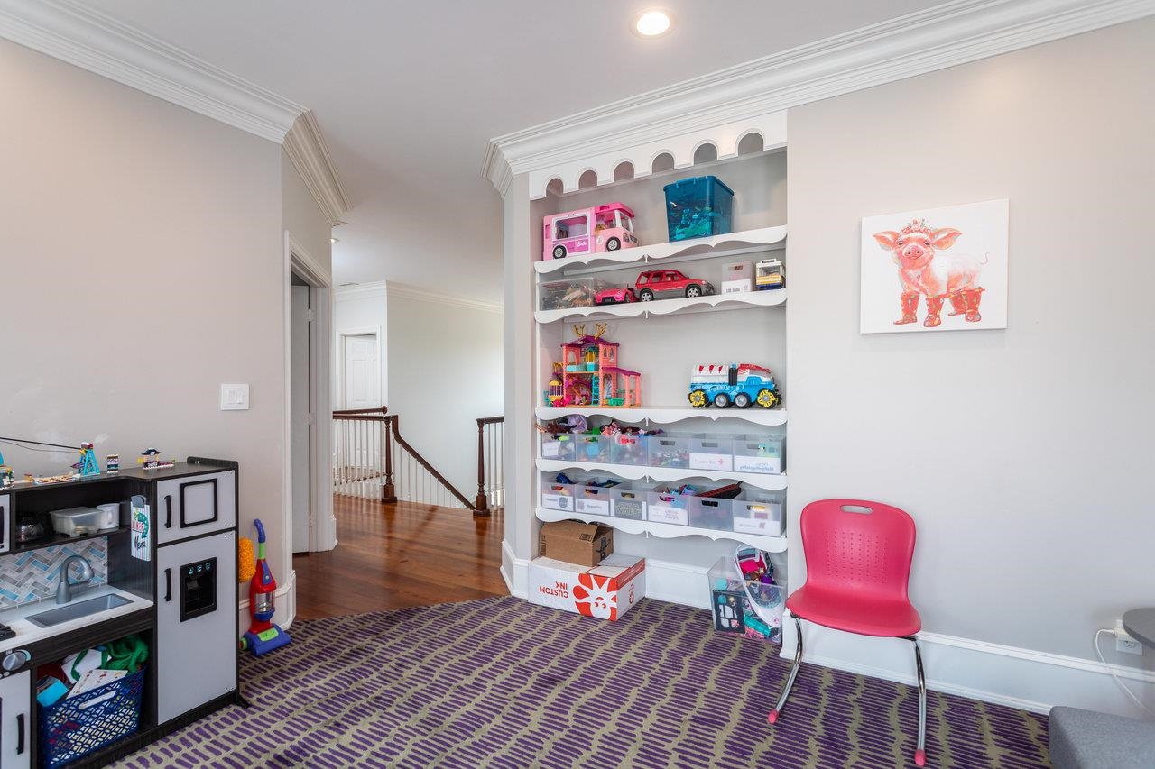 This room is currently used as a playroom. However, the shelving area can easily be turned back into a closet