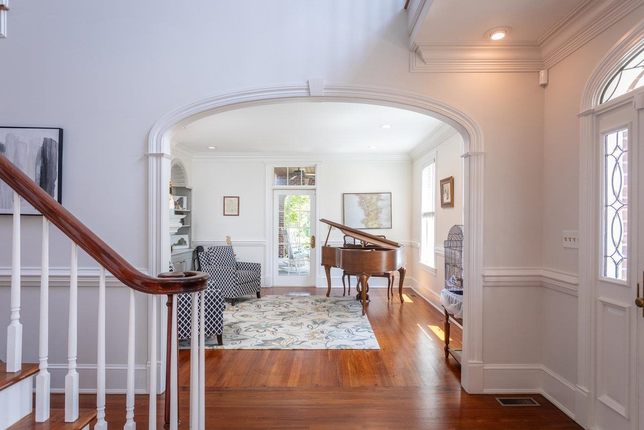 Arched entries, triple crown molding, wainscoting, extra wide baseboards, hardwood floors are just some of the exceptional features of this home