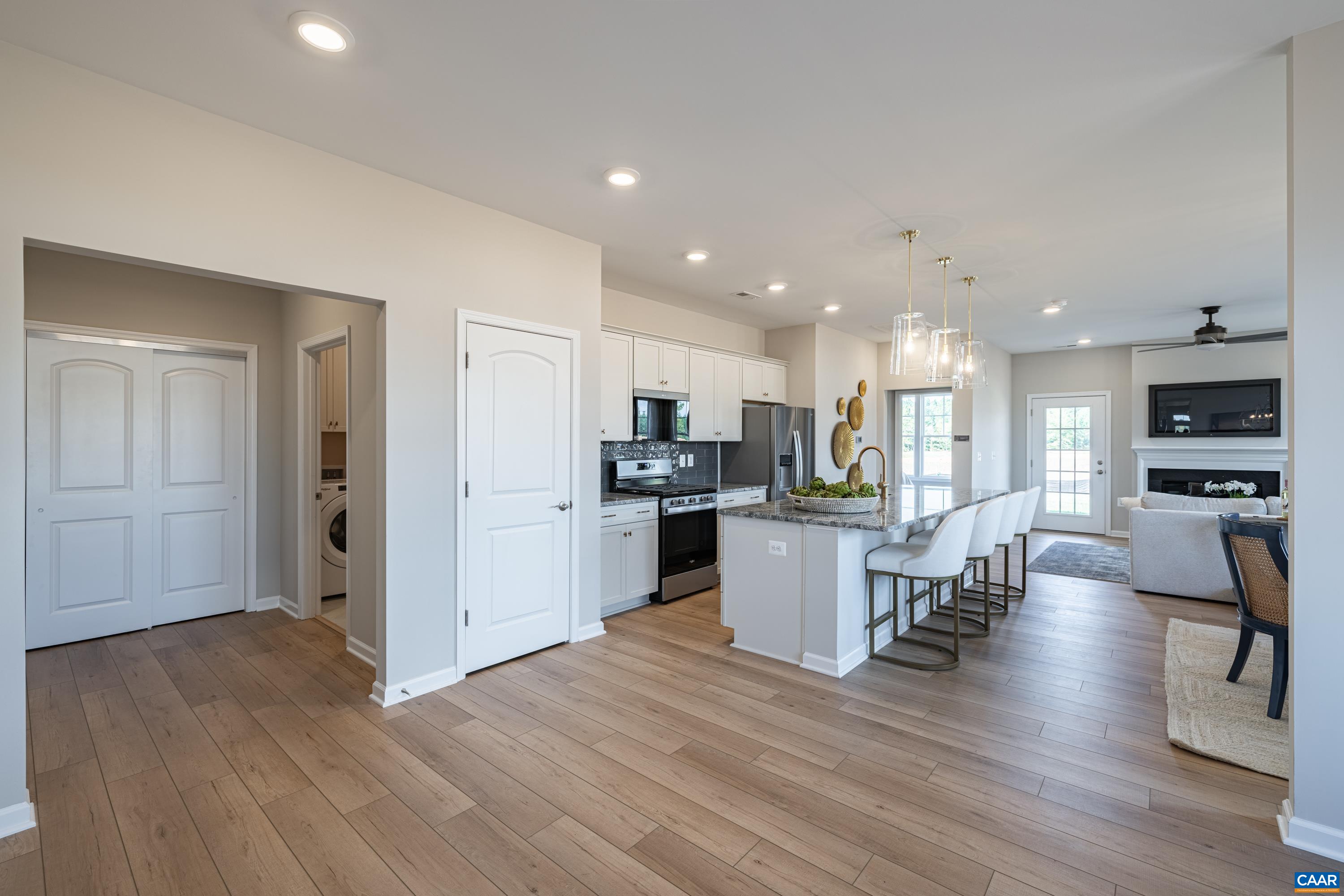 Model home showing great room, kitchen, owner's entry areas.