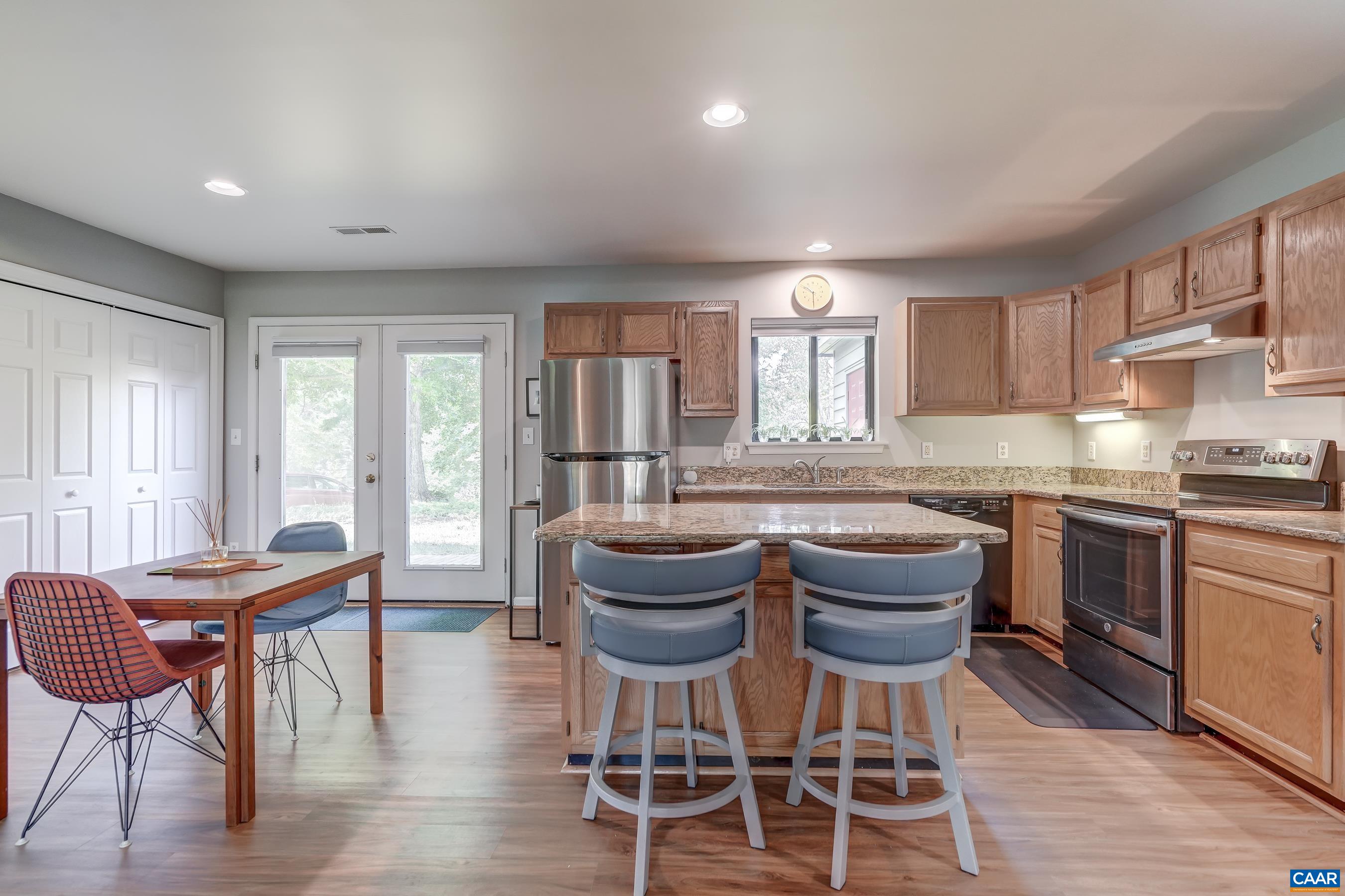 Functional kitchen with island worksurface/bar.