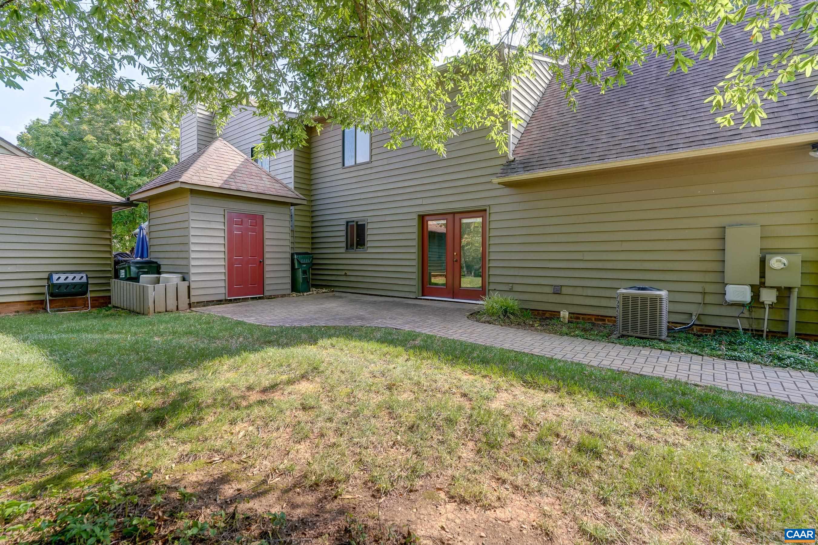 Shaded brick patio at rear of home.