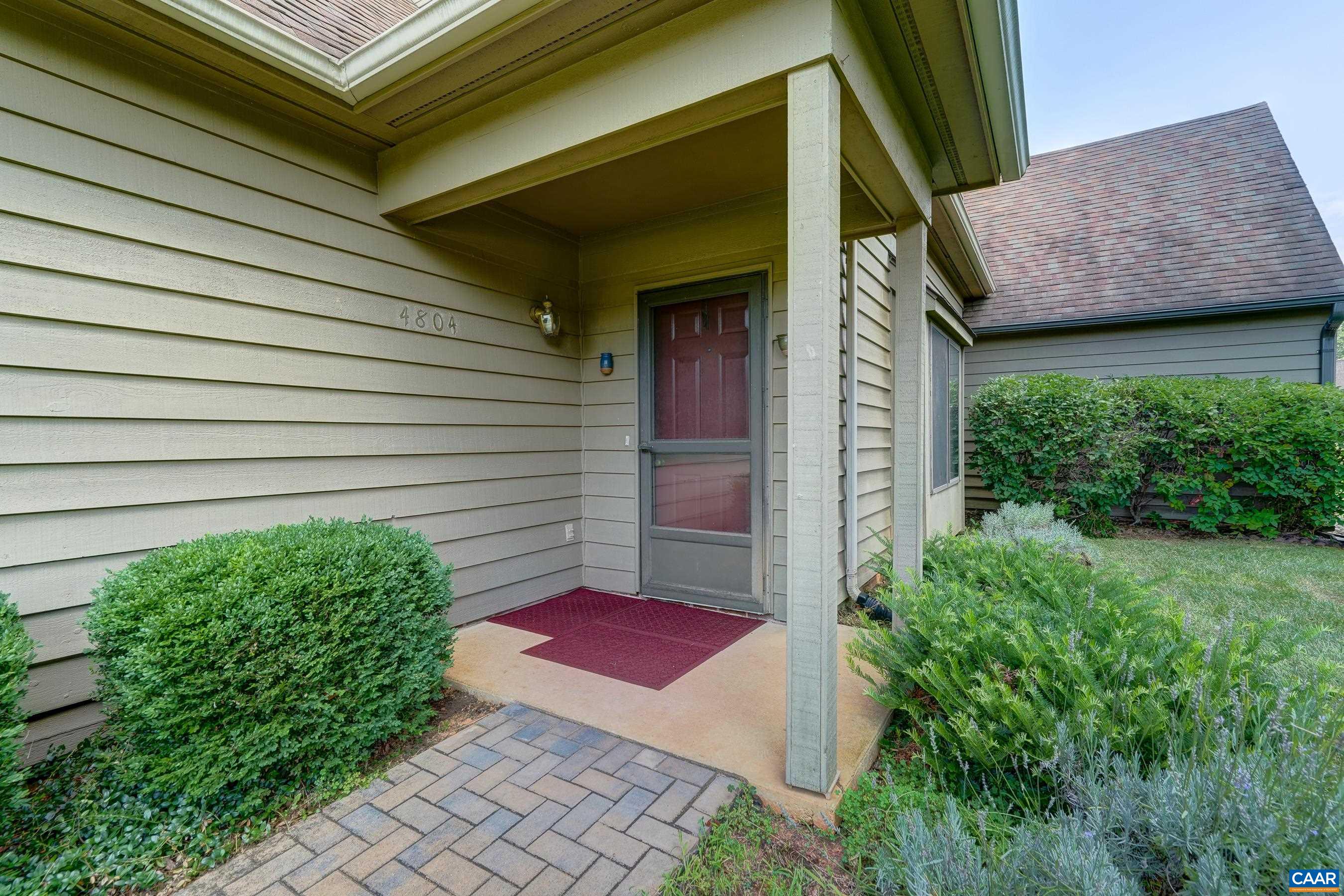 Covered front porch with storm door.