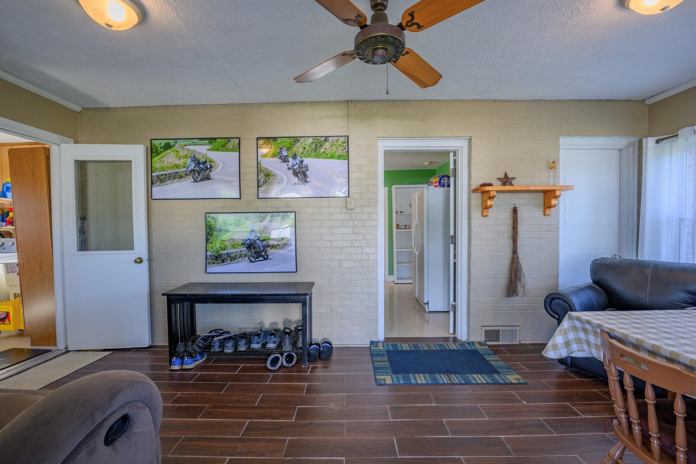 Enclosed side porch with breakfast area.