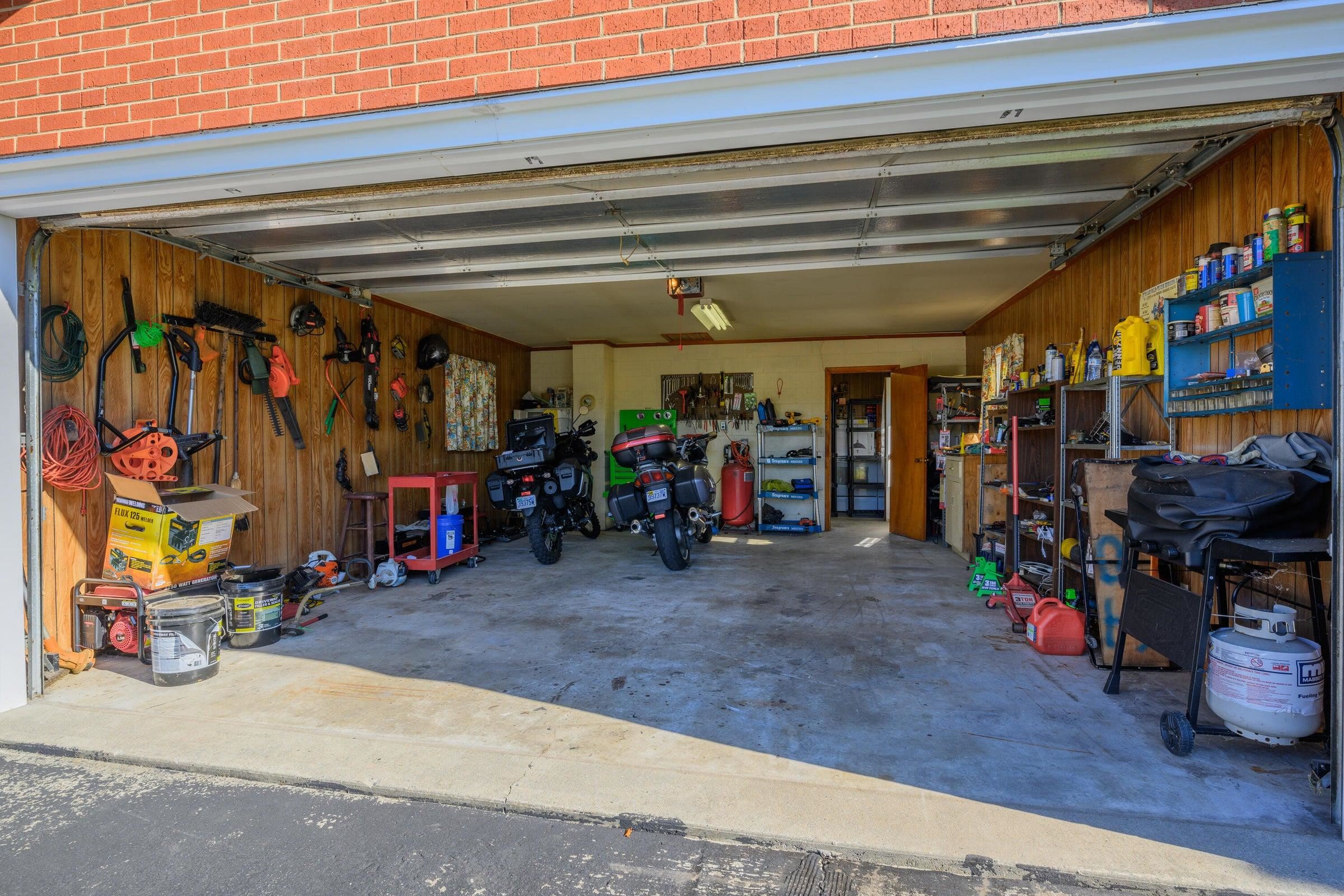 Garage with plenty of workspace and storage.