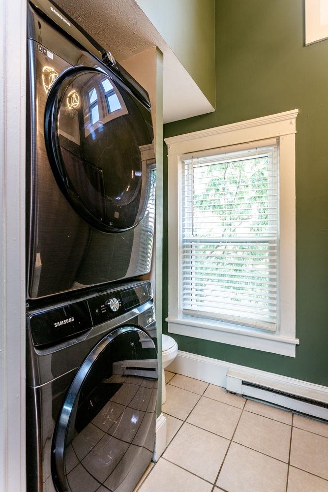 Laundry on upper level in hall in full bath.