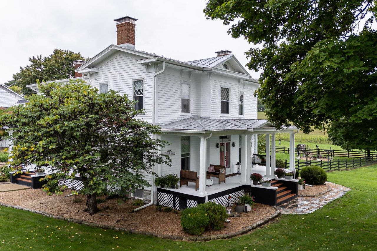 Main House with View of Covered Side Porch & Landscape