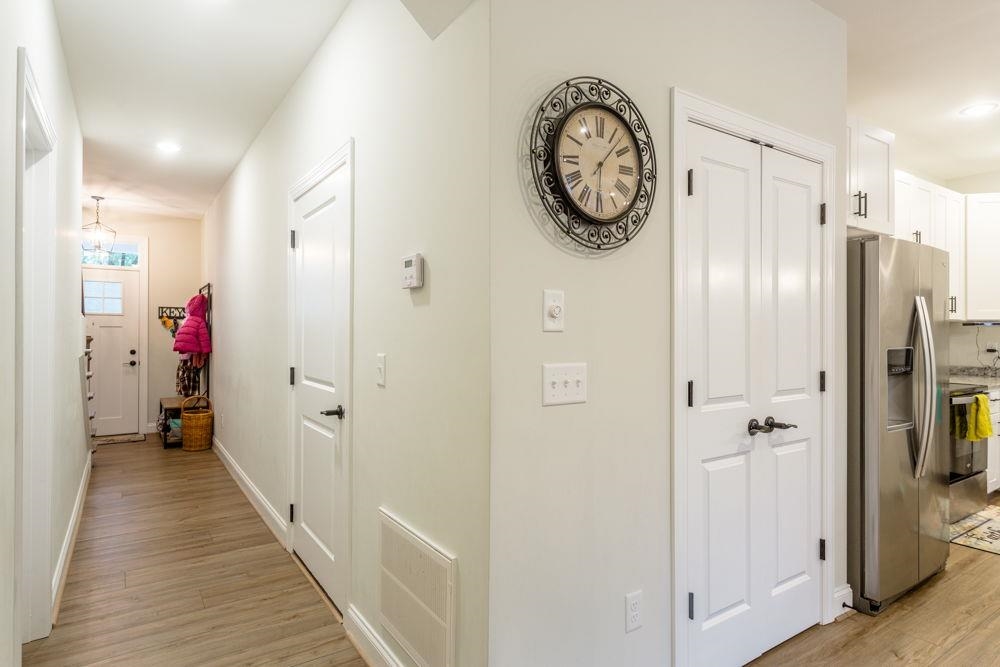 Front entrance with view to living room. 1st door on left is to the garage. Right is the 1/2 bath.