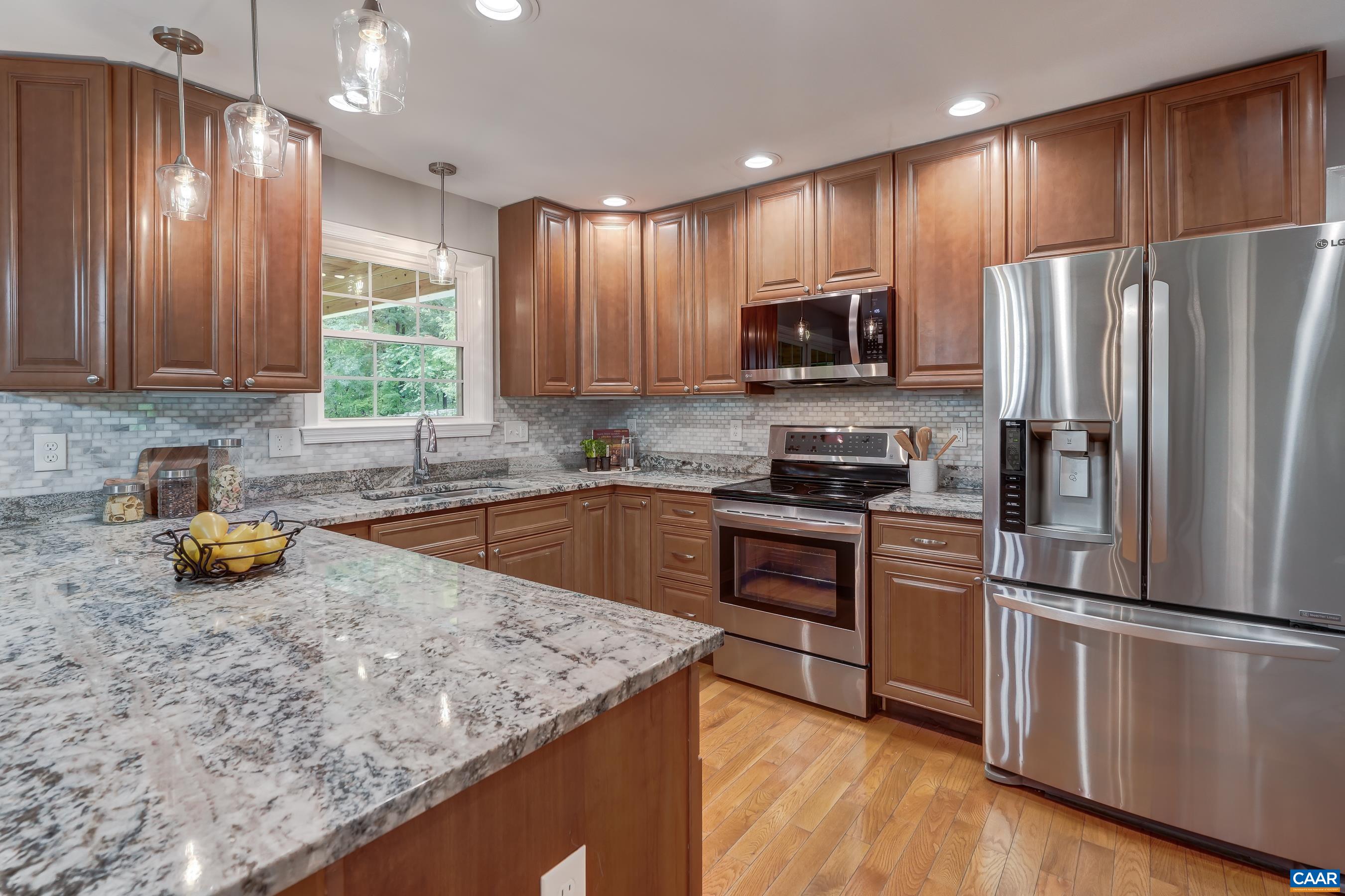 Chef's kitchen features cherry cabinets with granite countertops.