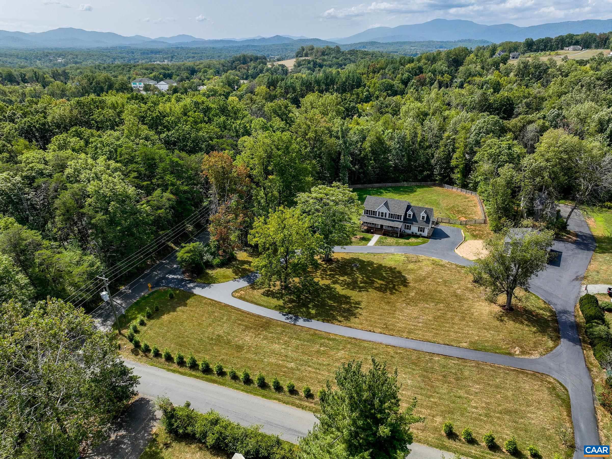 Tree-Surrounded property features two detached garages with 6 bays.