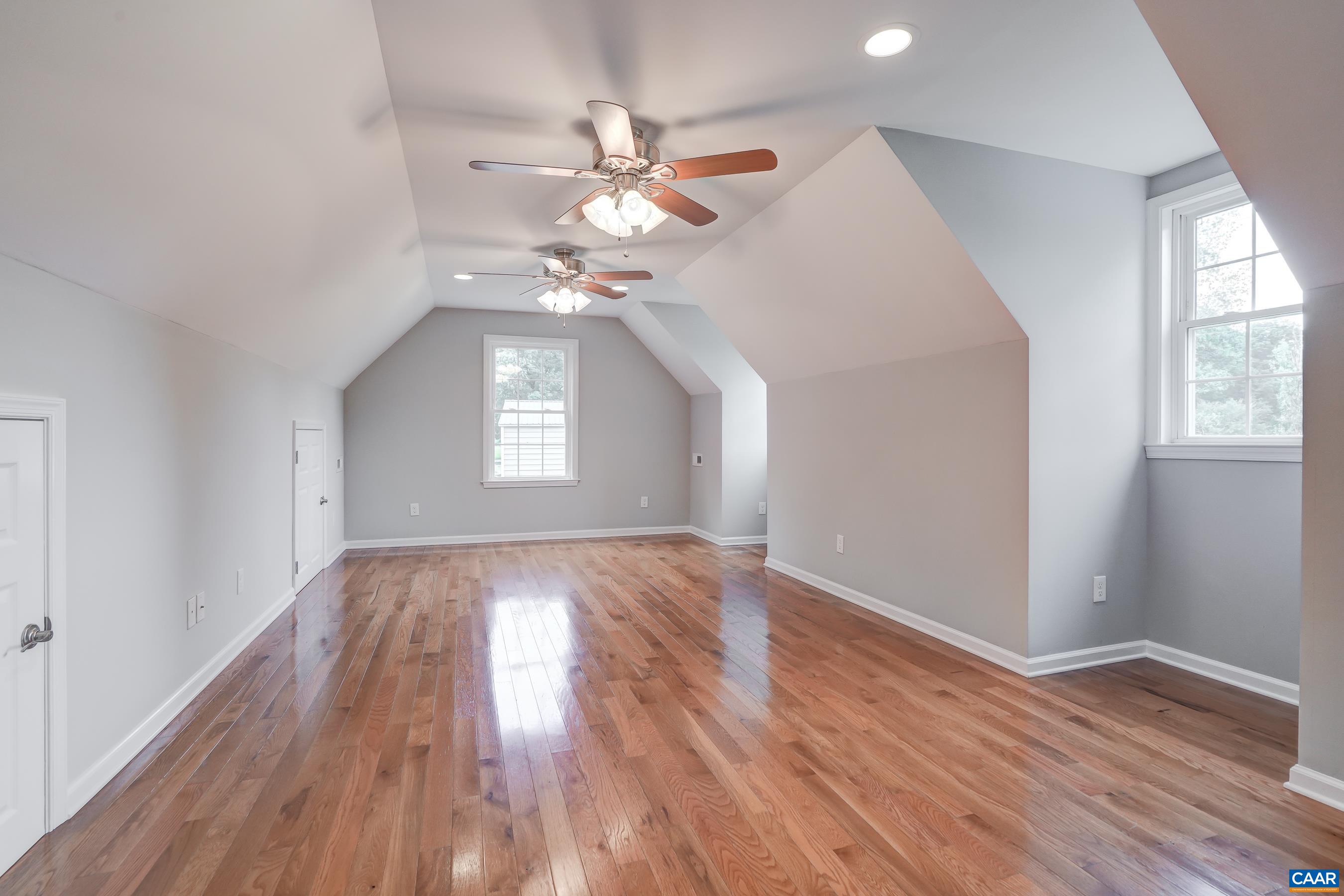 Bonus room over garage features two dormer windows, and could be a bedroom, workout space, or media room.