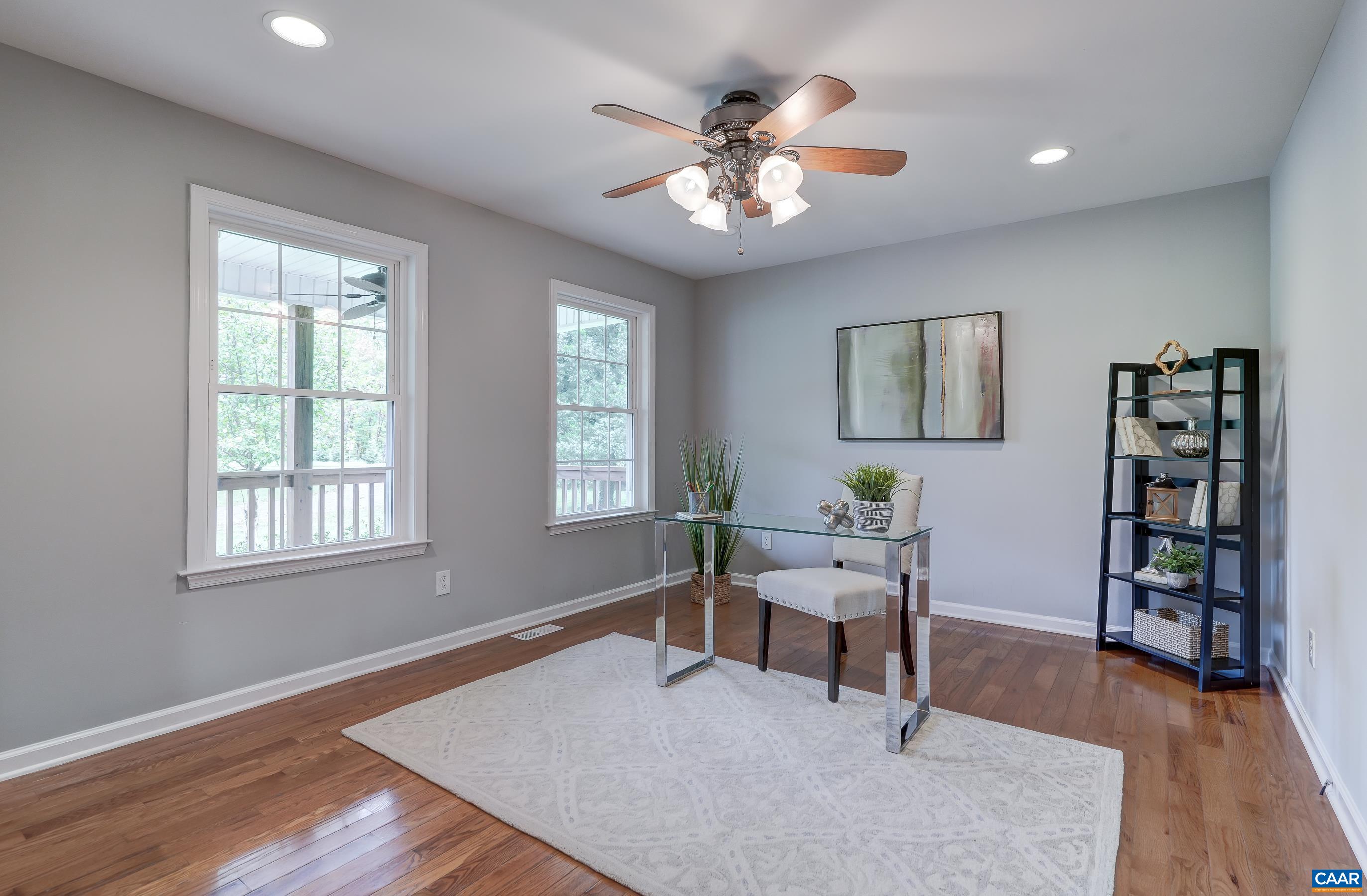 Home office at the front of the home includes a ceiling fan.