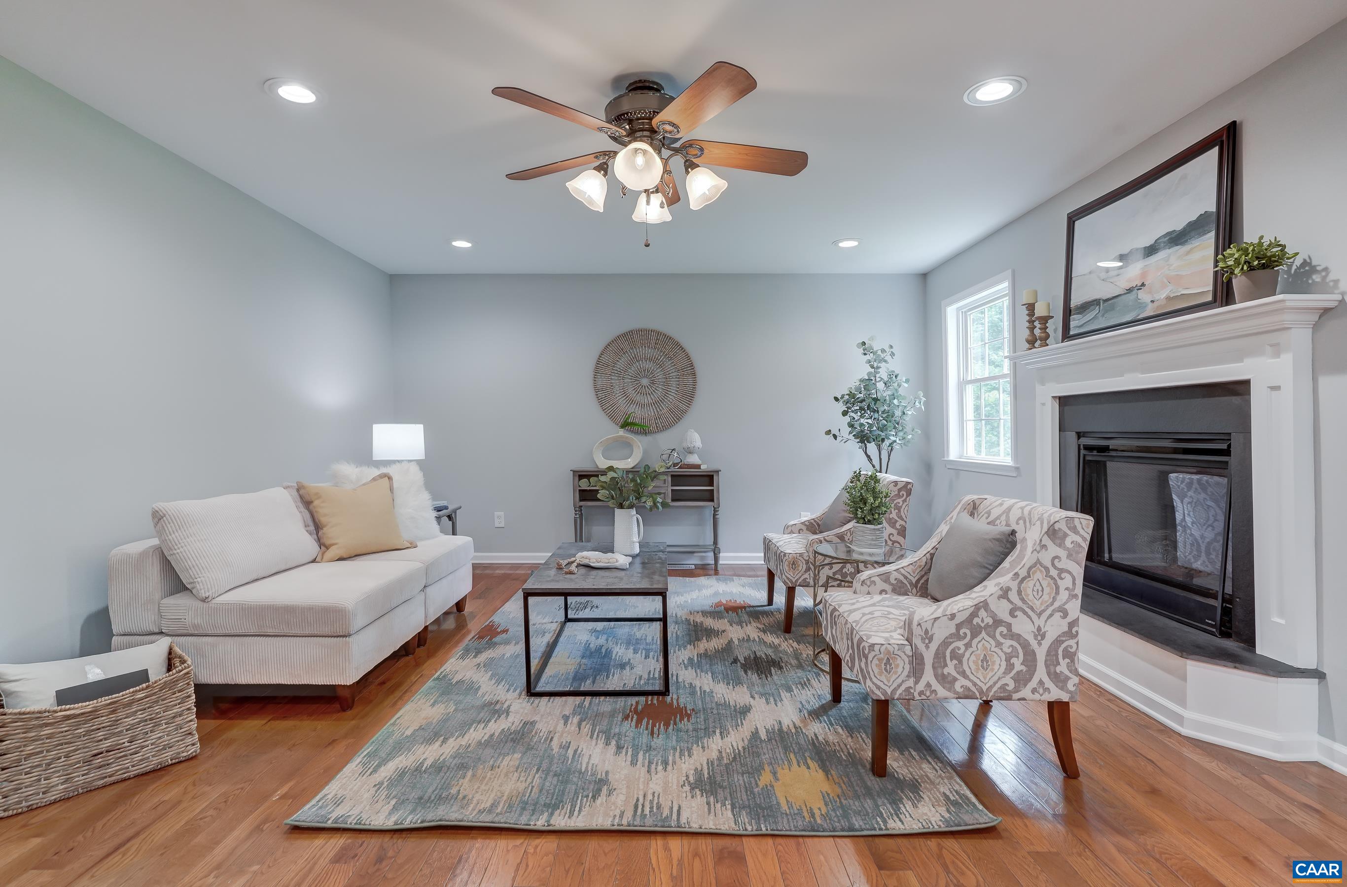 Living room features a gas fireplace with slate surround and ceiling fan.