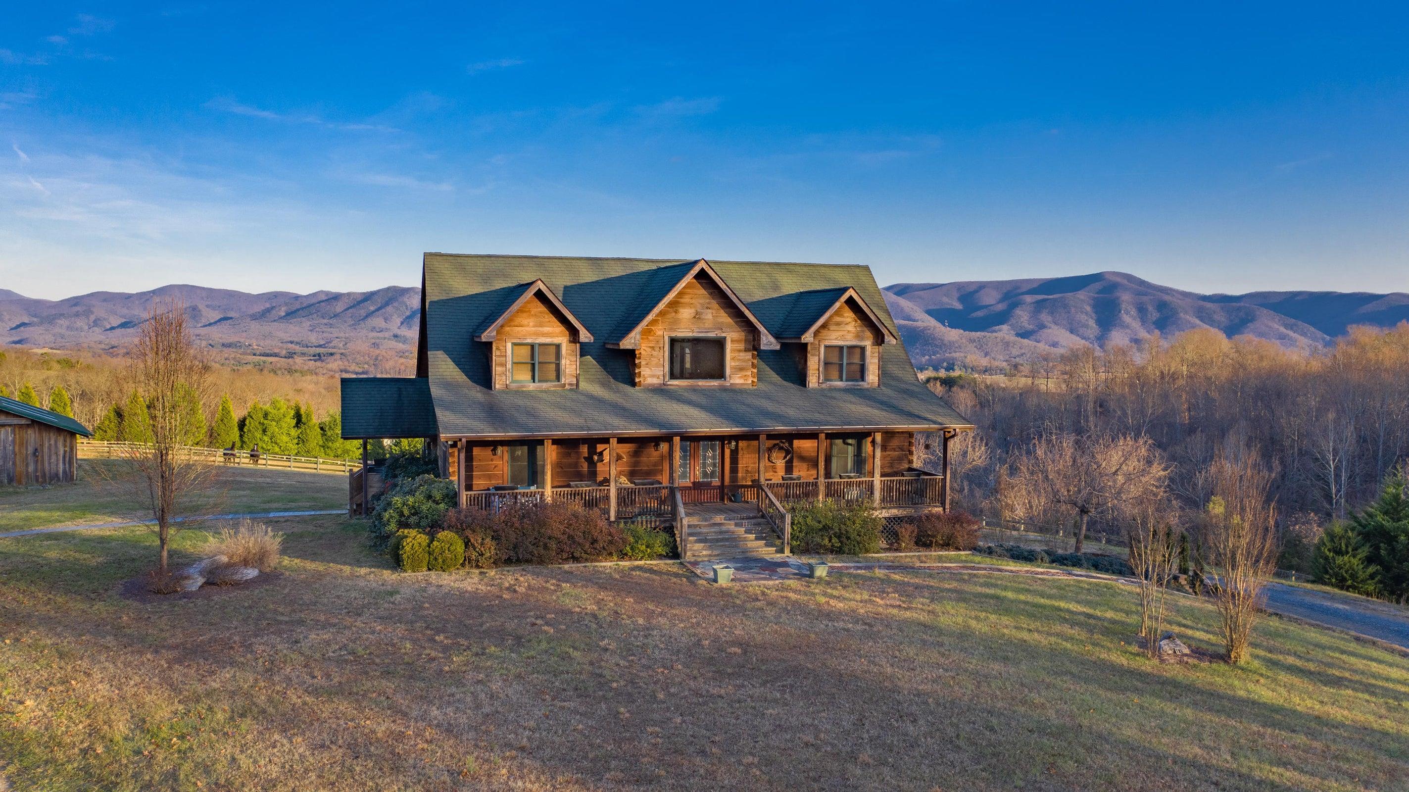 Winter, setting sun reflects off the Blue Ridge Mountains -- and the lovely home!