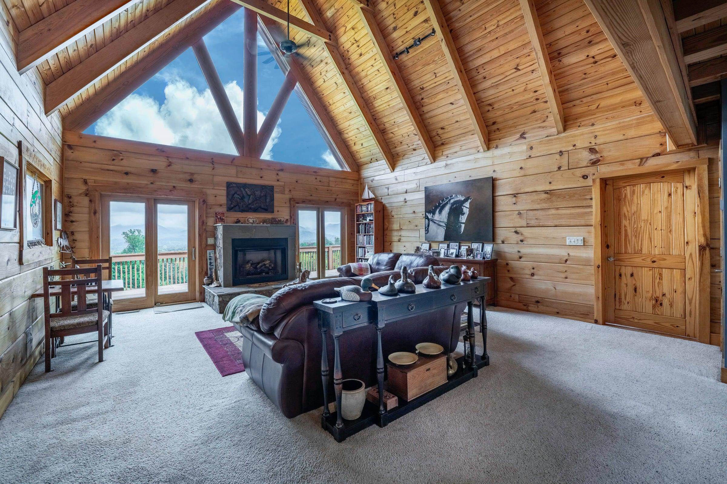 Great room with view of mountains. Stunning fireplace. Doors exit onto the rear deck. Light and bright!