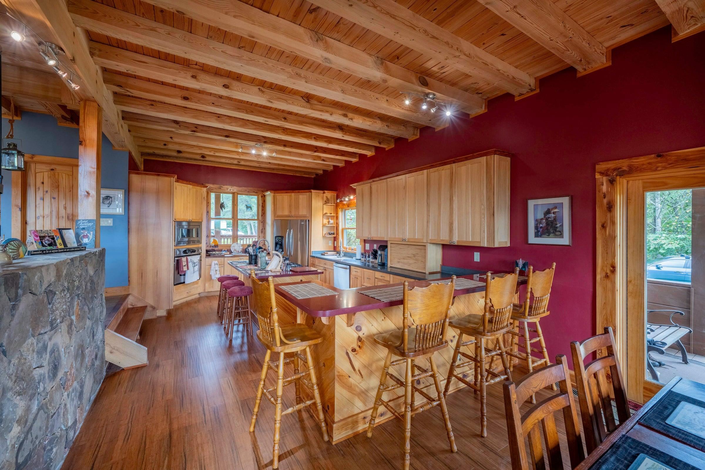 Looking into the kitchen, featuring a counter and seating.