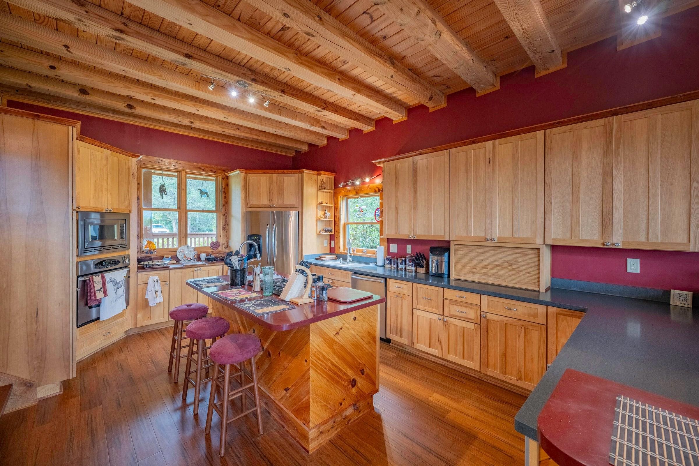 Beautiful, spacious kitchen with a central island featuring seating.