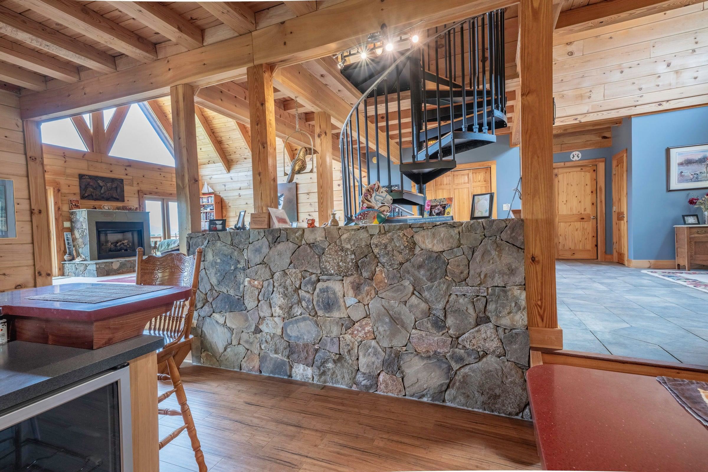 Picturesque, stone wall partially encloses the kitchen area from the Great Room.