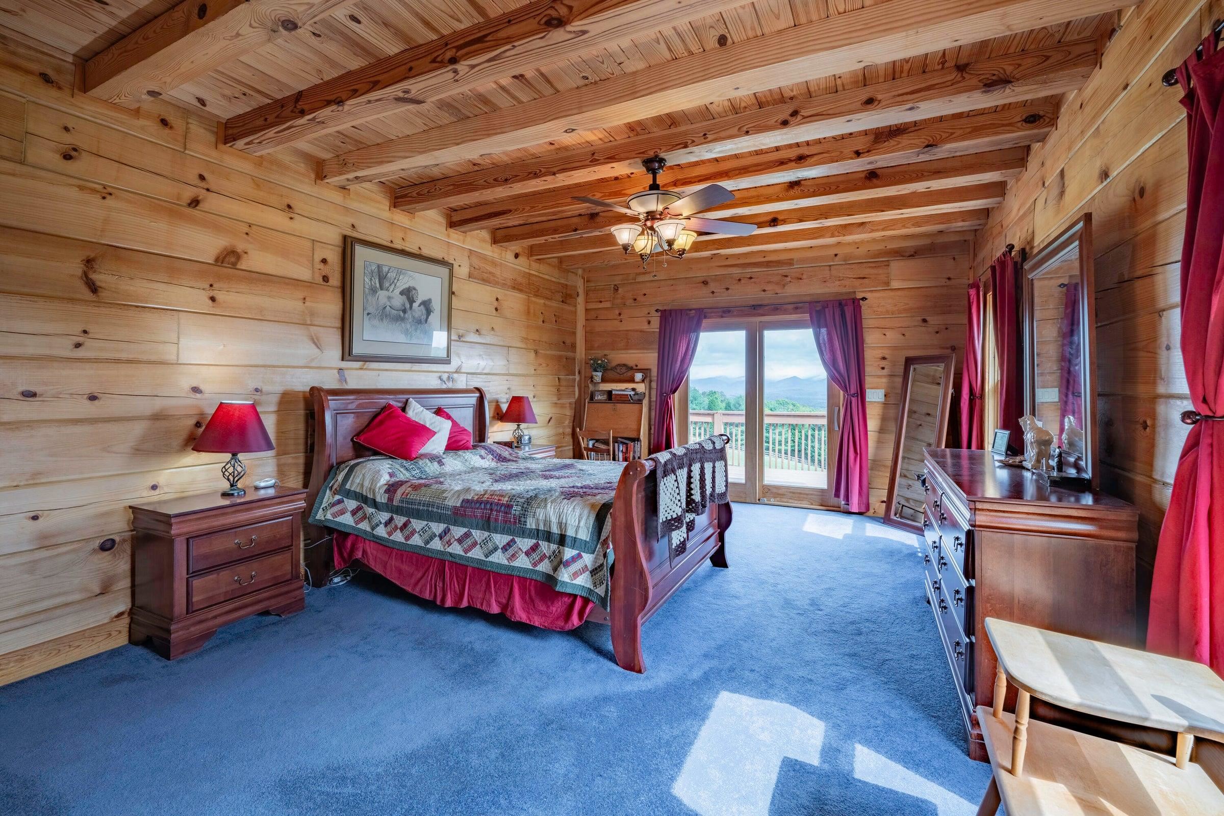 Primary bedroom has door to the expansive deck and Mt. views.