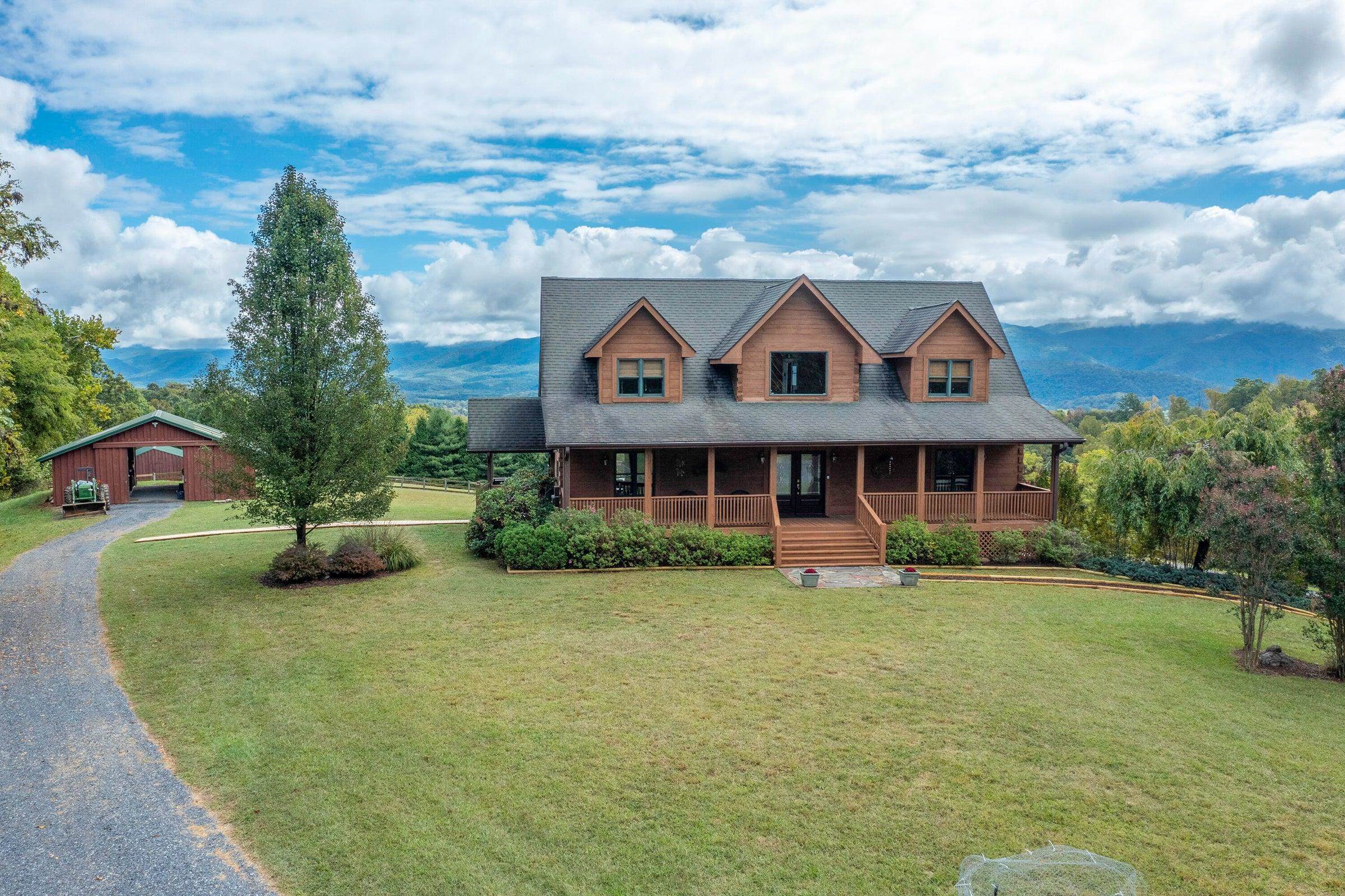 Horse barn is easily accessible, just behind the Post & Beam Log Home.