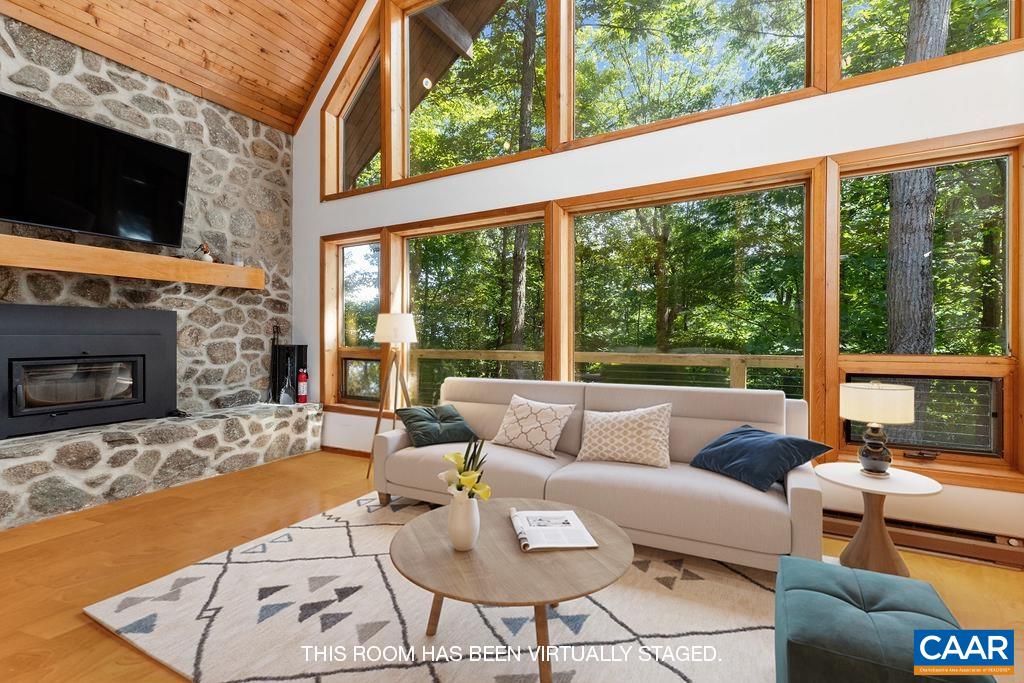 Wall of glass to enjoy the beautiful mountain and sunrise views in the winter and the privacy of the mature hardwoods in the summer.