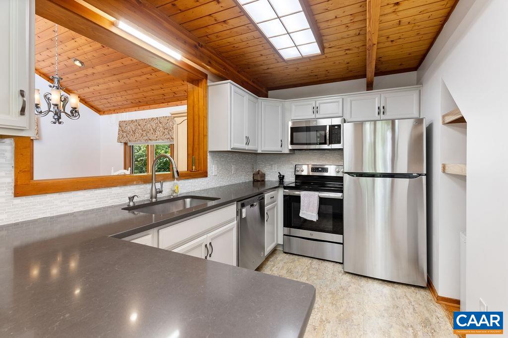 Beautiful kitchen with quartz counter tops and stainless steel appliances.