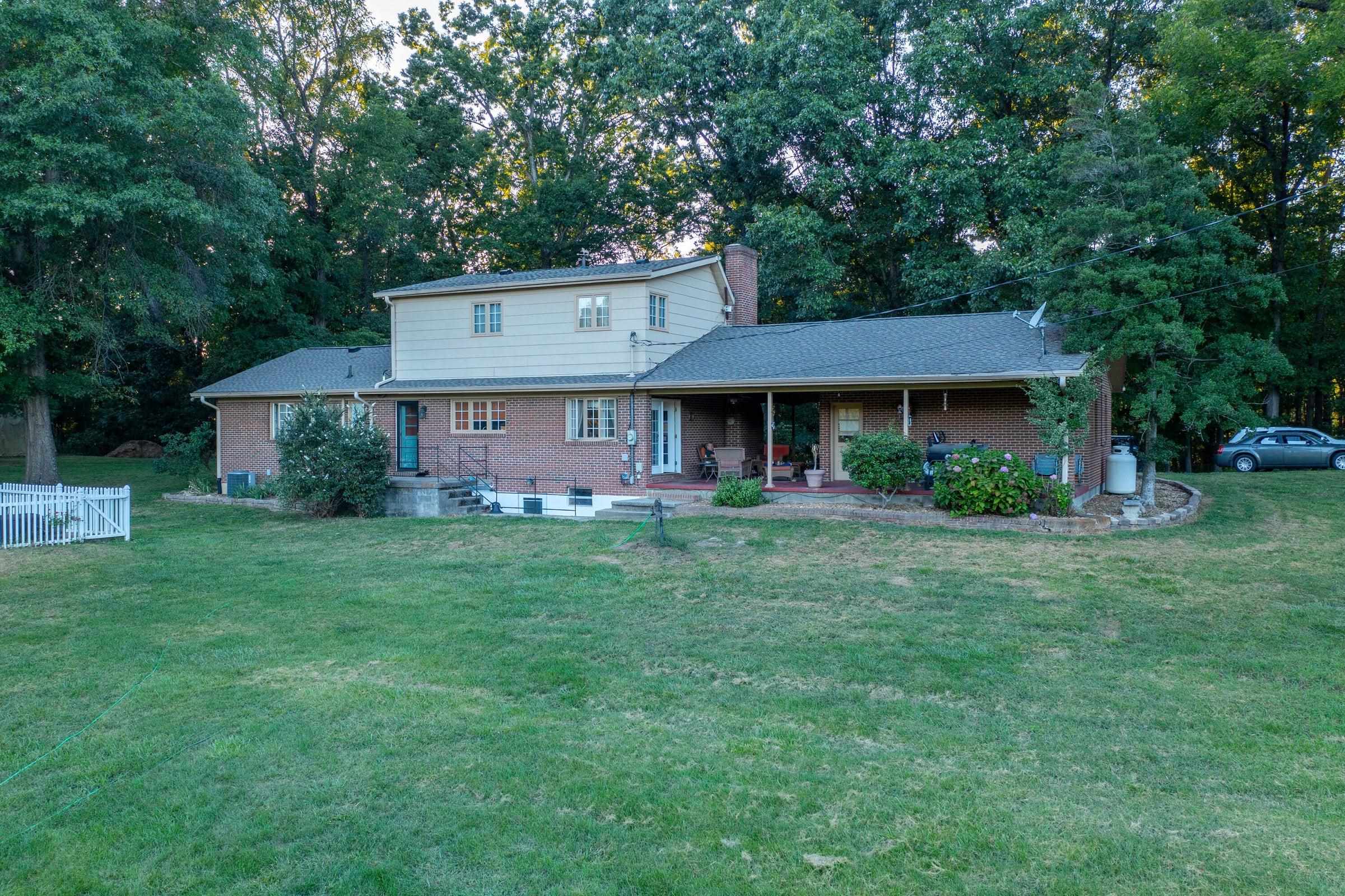 Watch your horses from the covered breezeway between the house and the garage. Functions as an outdoor sunroom.