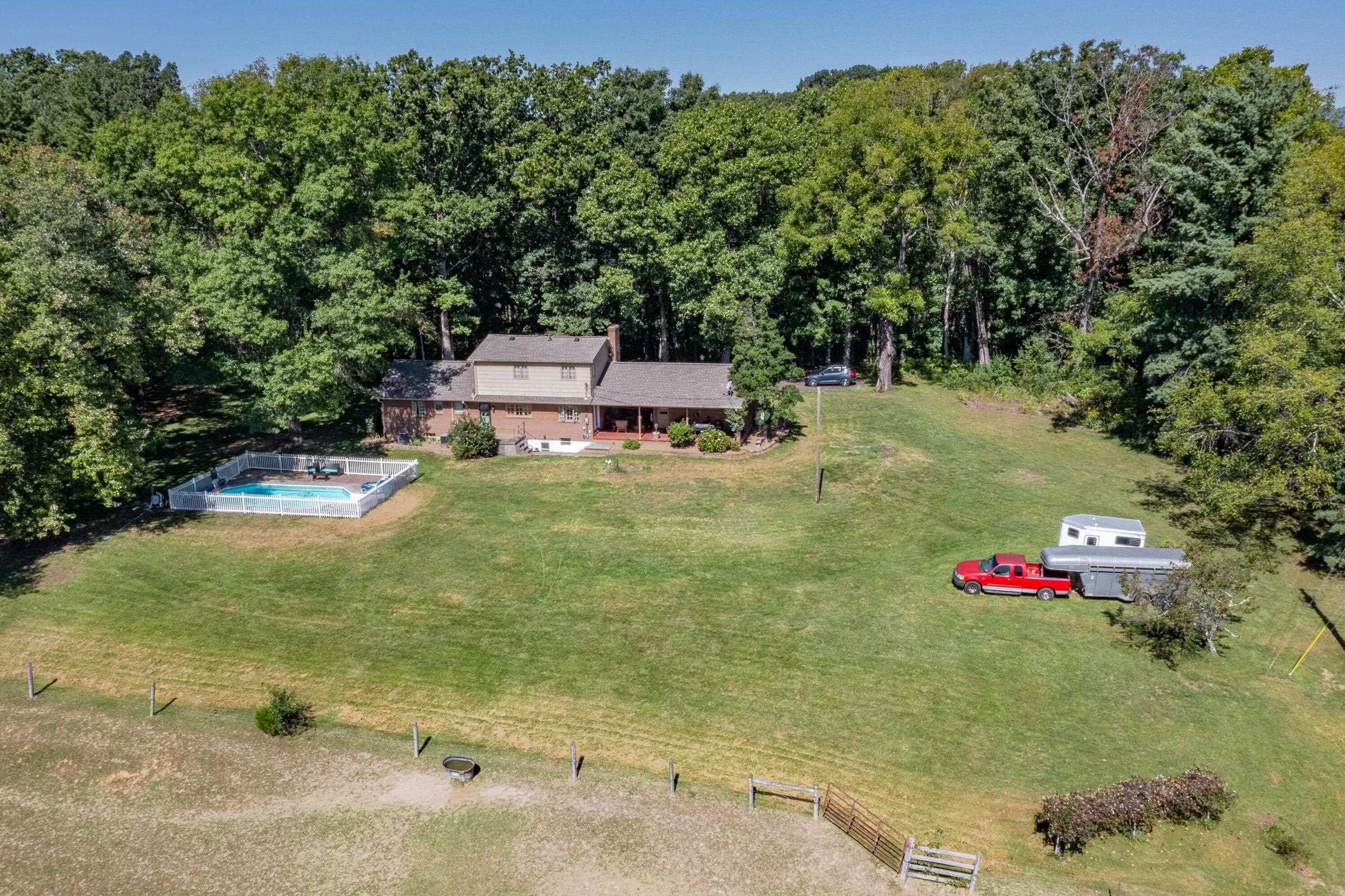 Lawns and gardens around the house -- fenced pastures below.