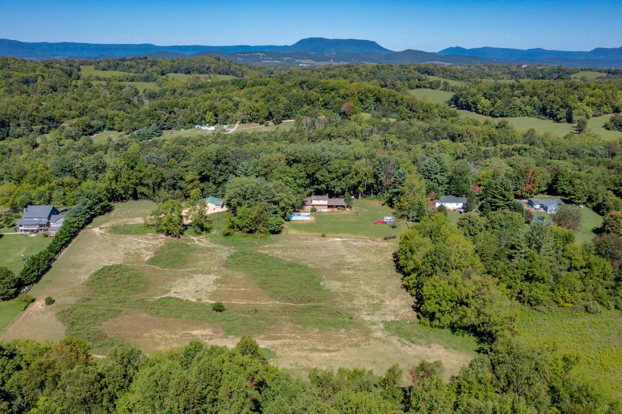 Over 7 acres of rich, fenced pasture bordered by forest. See the Alleghenies to the West.