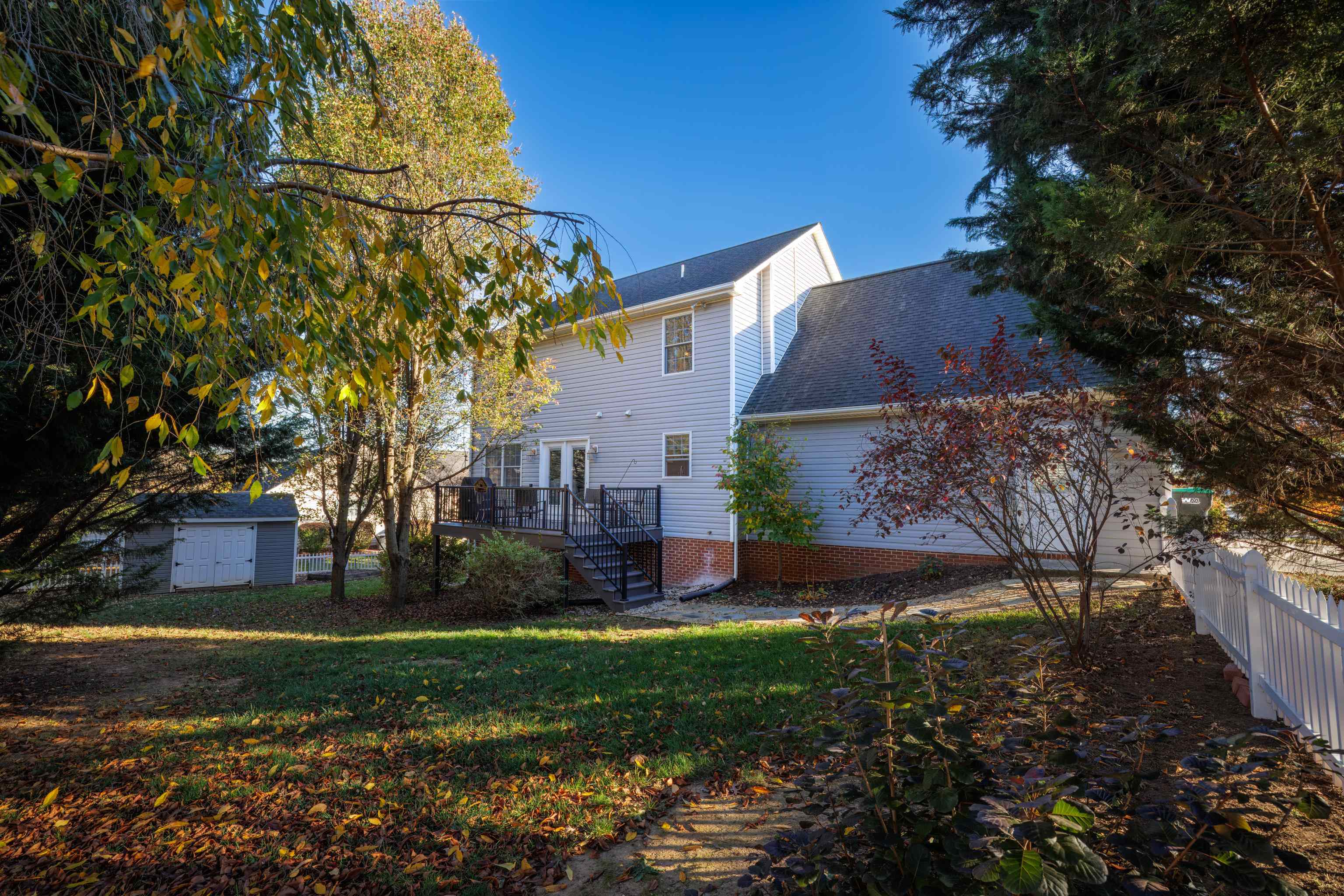 *backyard is improved with a vinyl fence and privacy trees