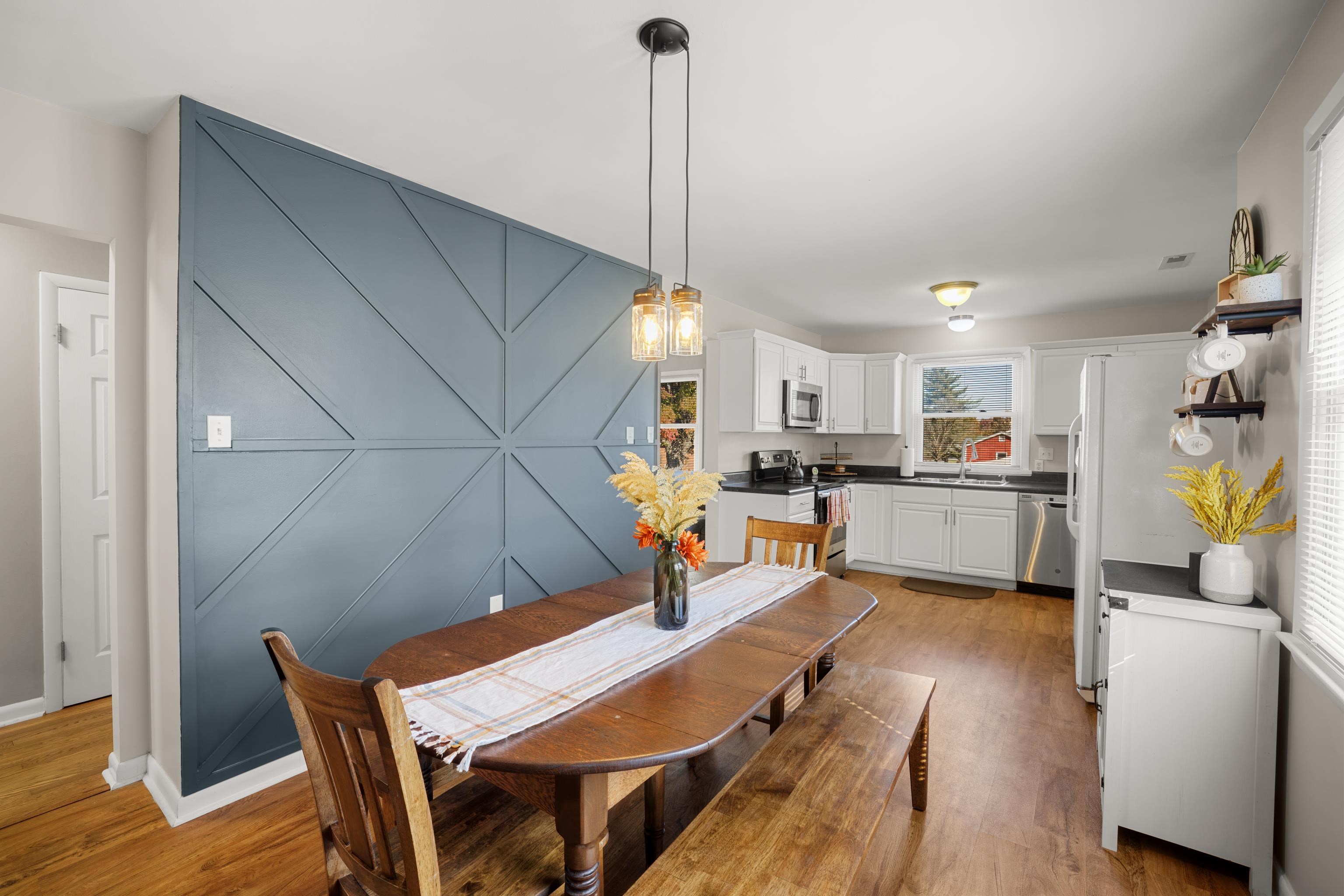 *beautiful accent wall, LVP Flooring, and barn door really add to this space