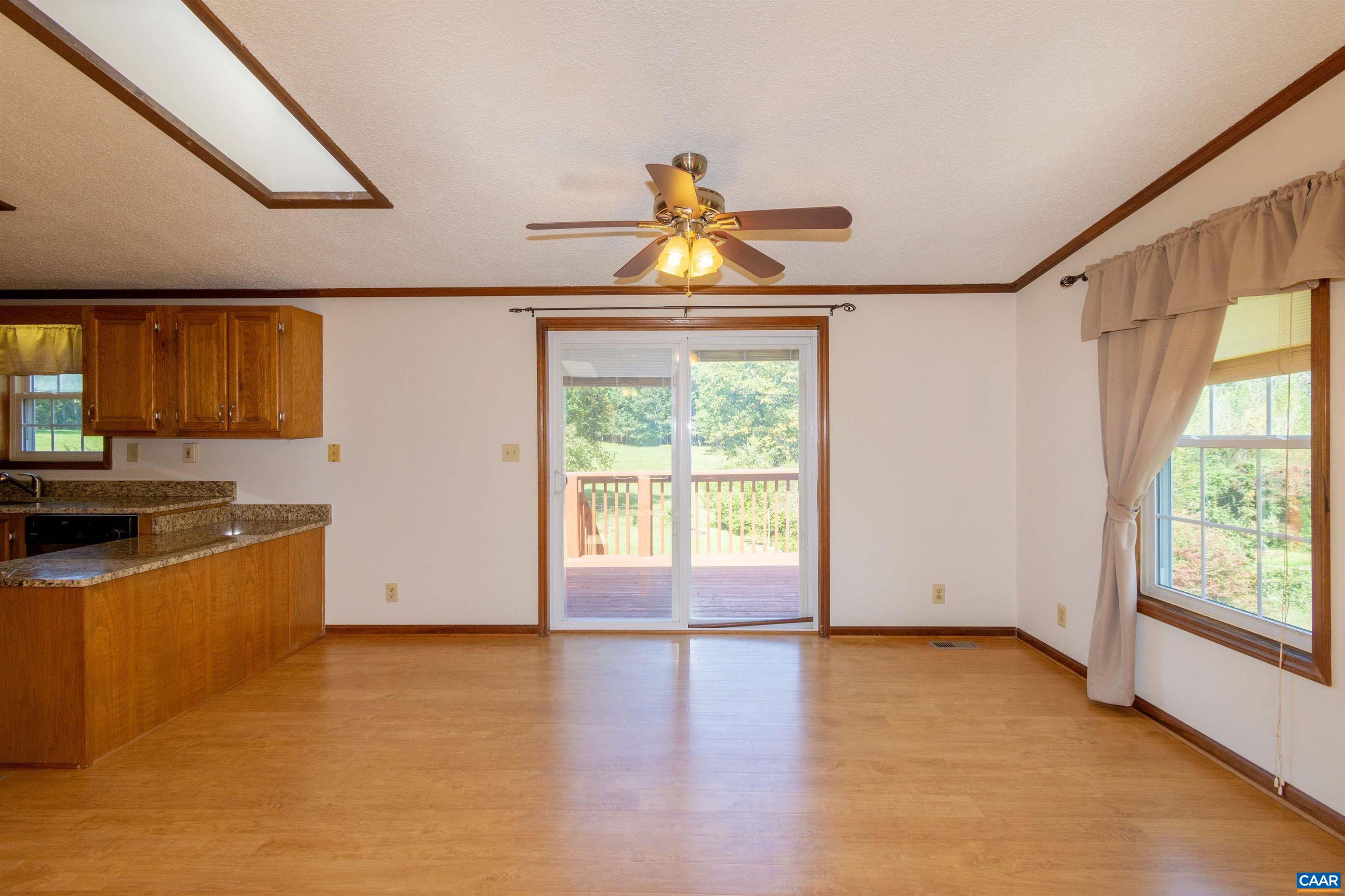 Open to kitchen and the living room. Dining area opens out to the spacious rear deck by way of sliding glass doors.