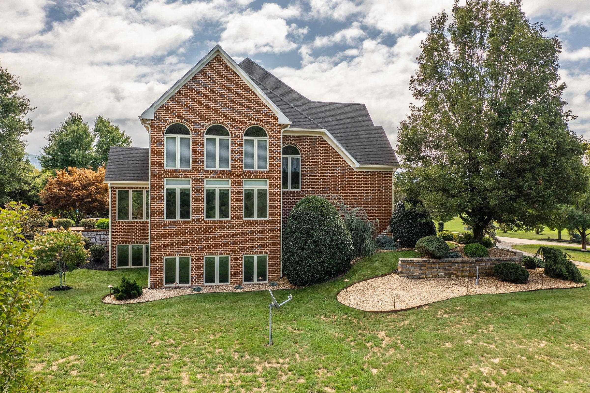 Impressive 3-story section at the side of the home, graced by artistic landscaping.