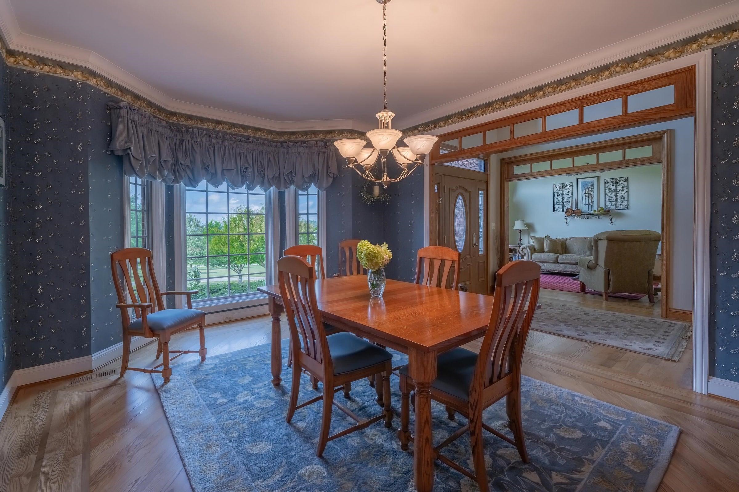 Notice the decorative walnut inlay gracing the oak dining room floors.