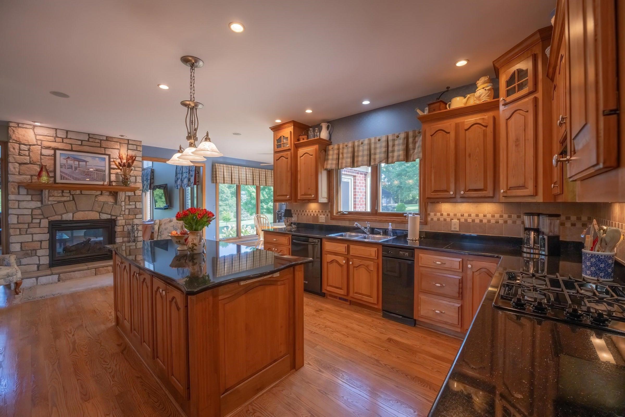 The stone fireplace is two sided. On side faces the kitchen, the other side the Great Room.