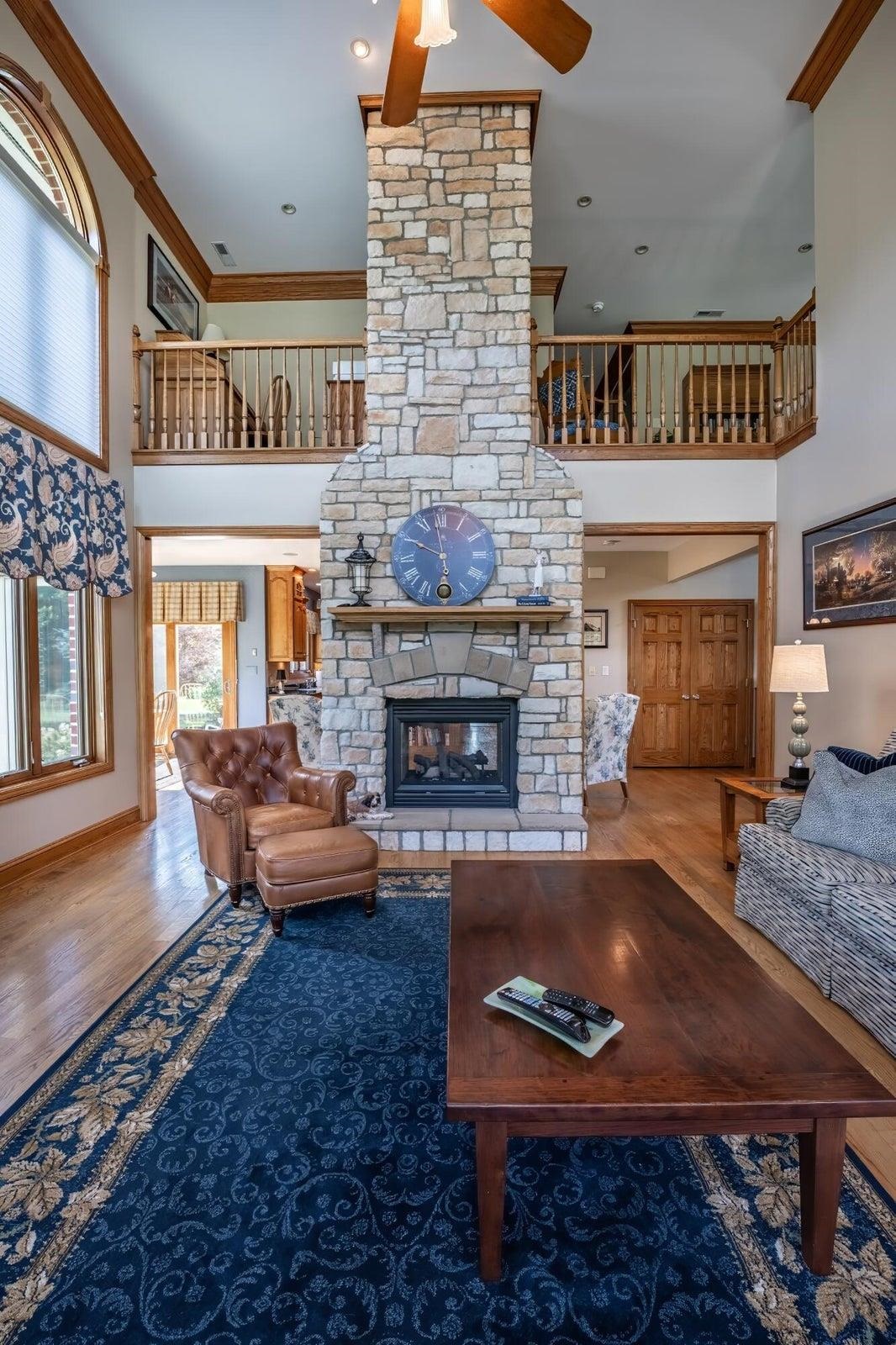 Two-sided fireplace. This is the Living Room side. Again,notice the 2nd story loft!