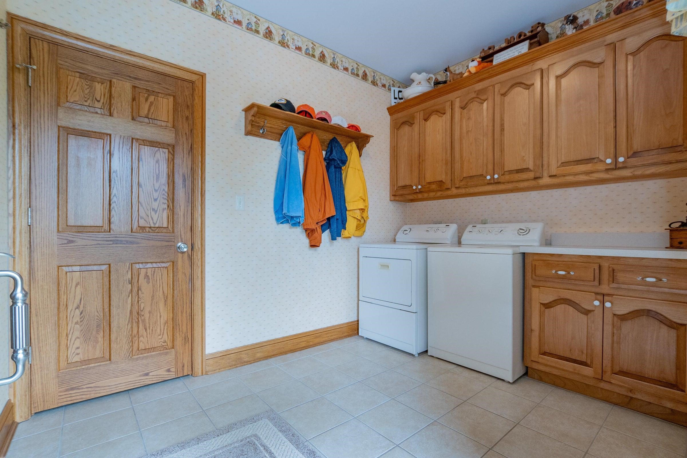 Laundry room offers plenty of storage.