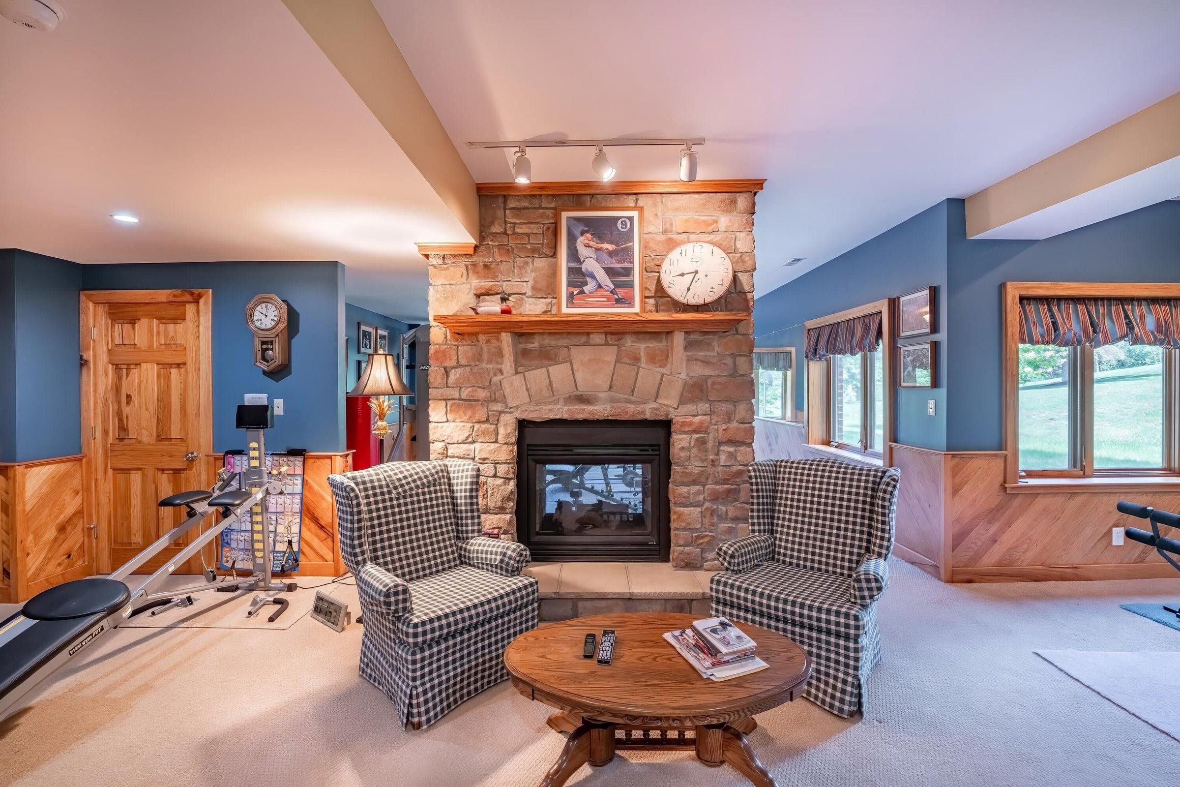 Another double-sided stone fireplace enhances the finished Lower Level space.