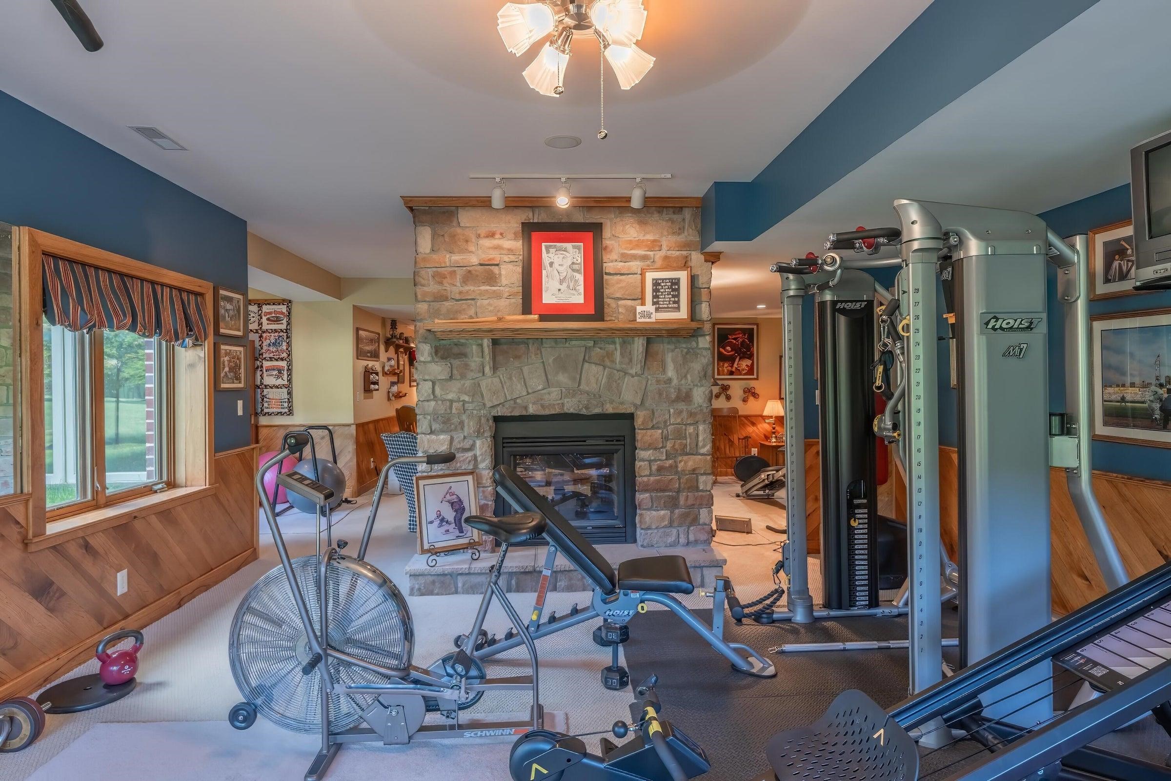 Gym  Exercise room side of the stone fireplace.