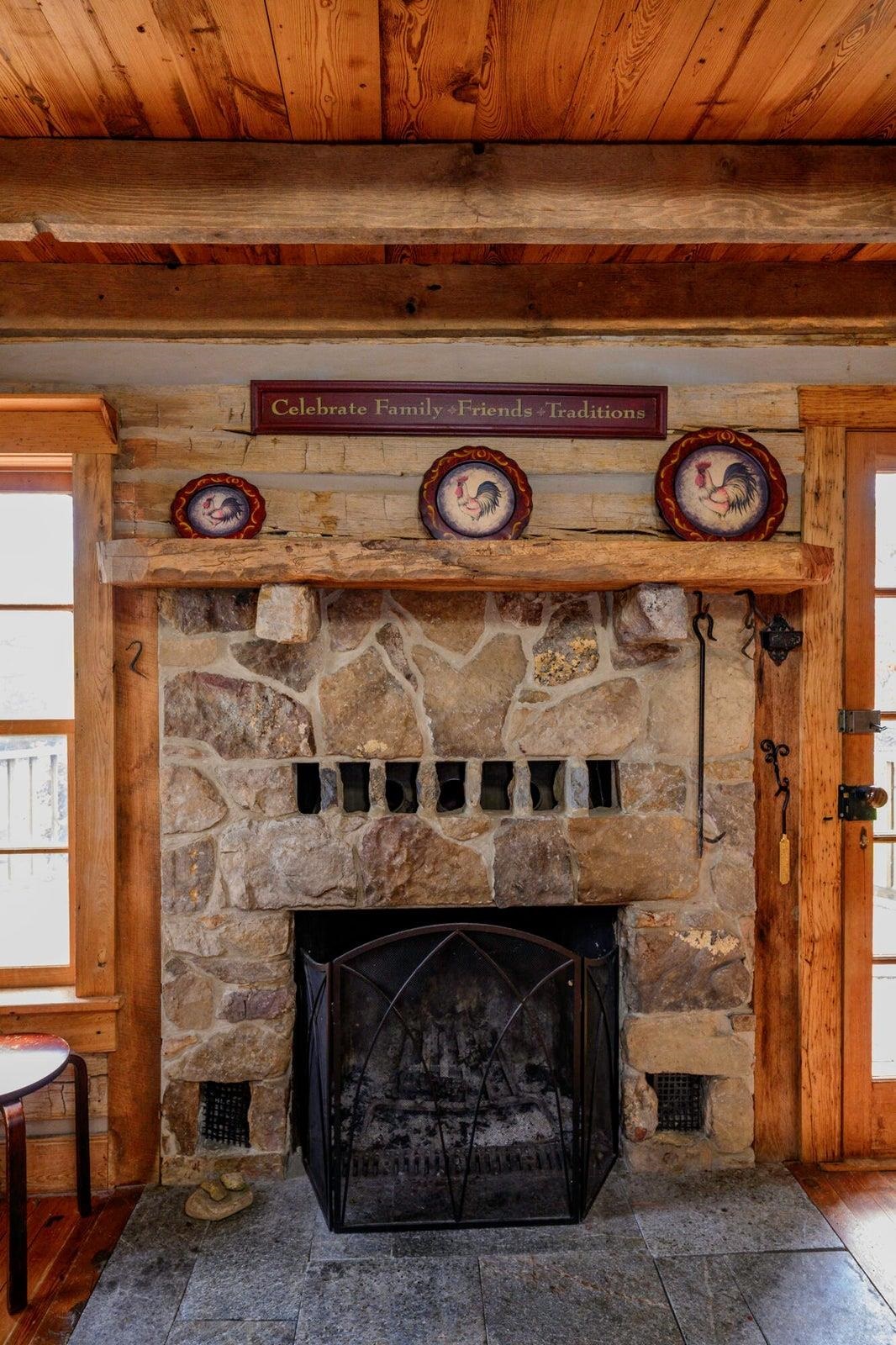 Stone fireplace in kitchen.