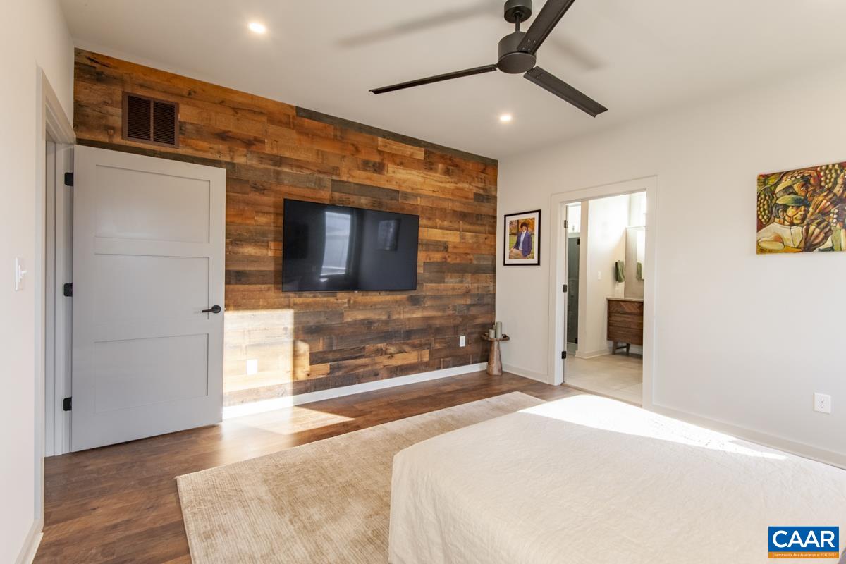 Beautiful primary suite with reclaimed wood accent wall.