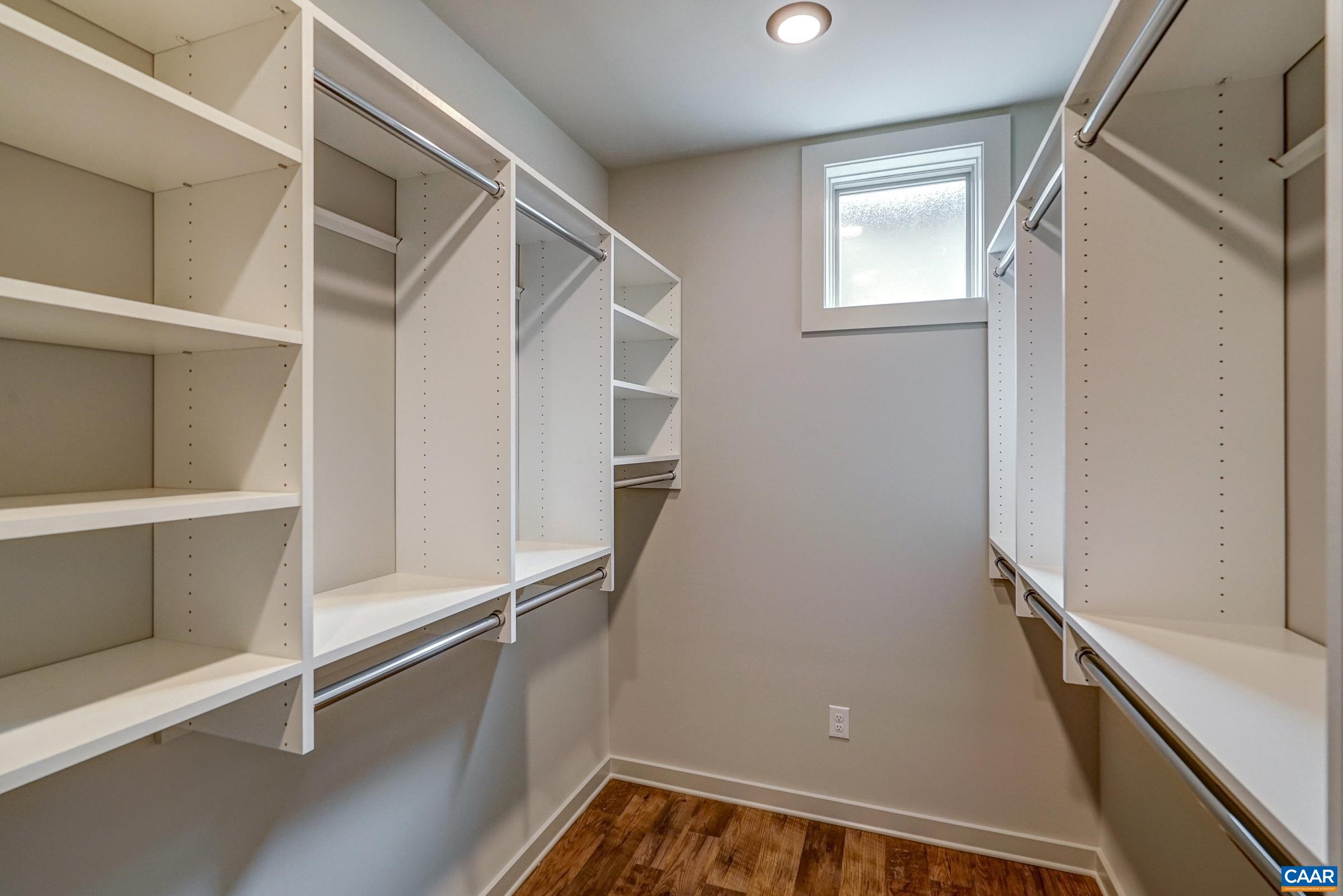 Two custom walk-in closets with built-in storage.