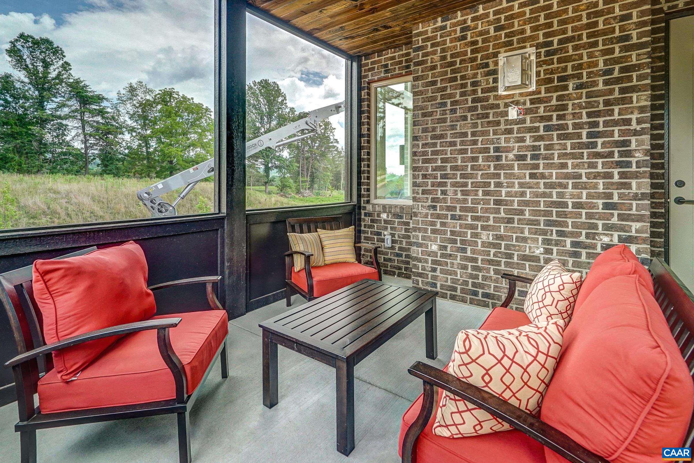 Screened porch on the main level is a beautiful spot for dining or entertaining.