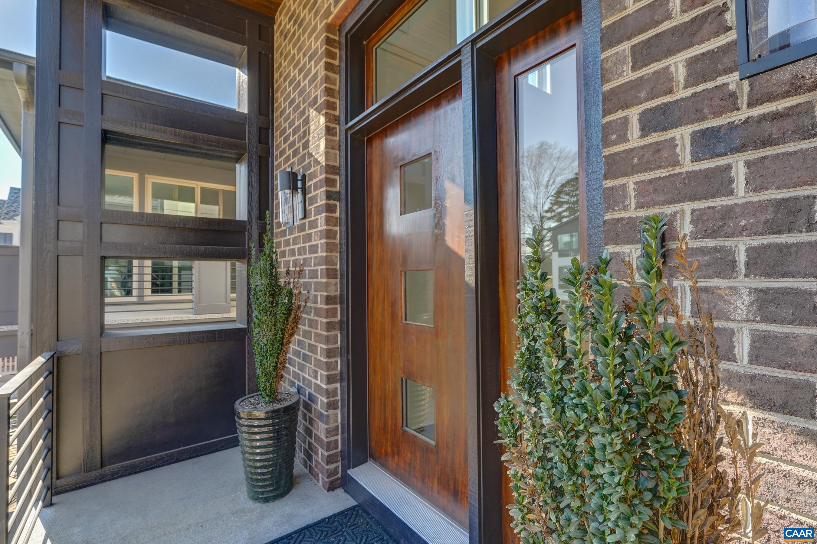 Welcoming front porch with stained hardwood front door.